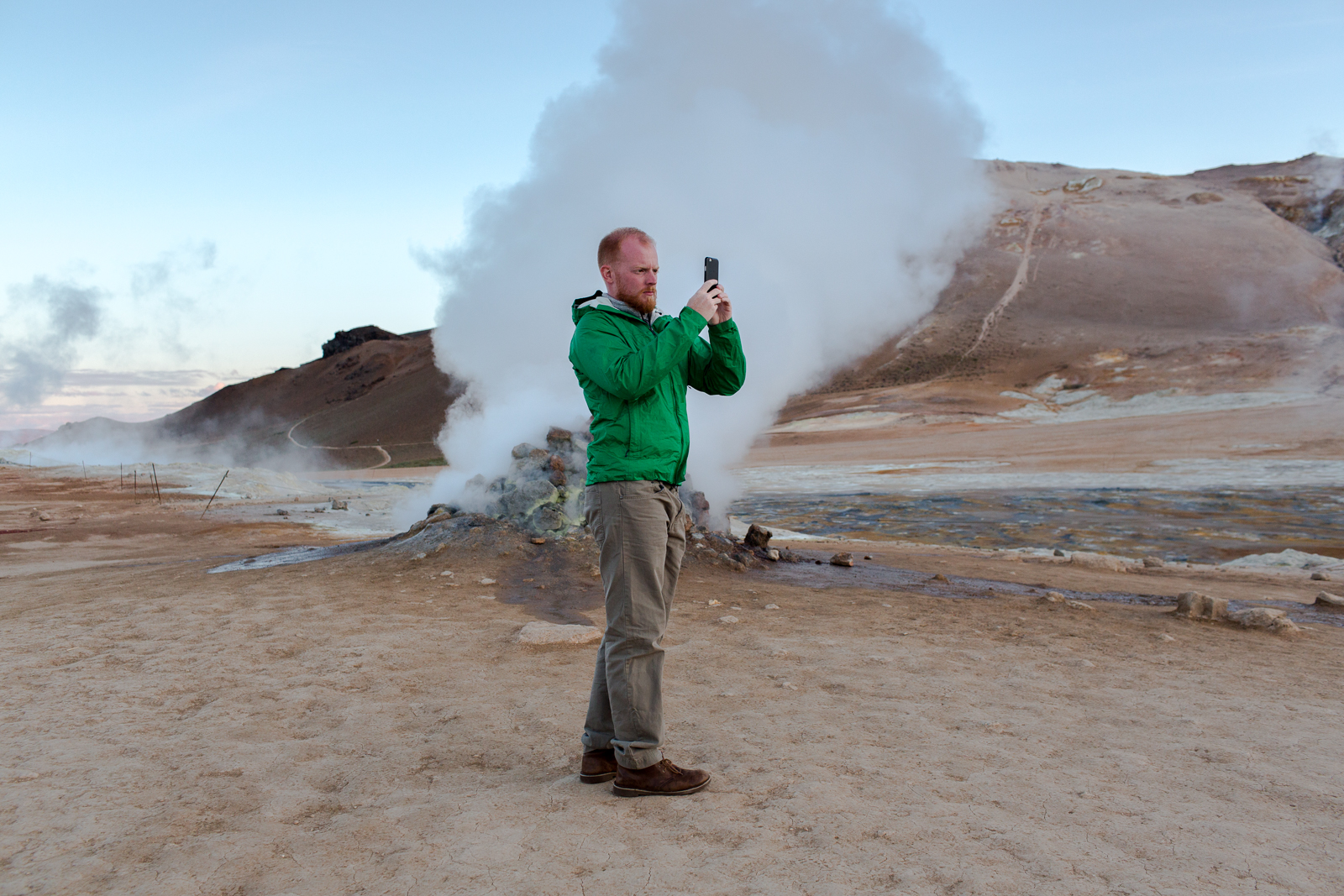  A tourist photographs steam escaping from a vent at Namafjall in in Lake Myvatn, a landscape covered with with mud pots and fumaroles. 