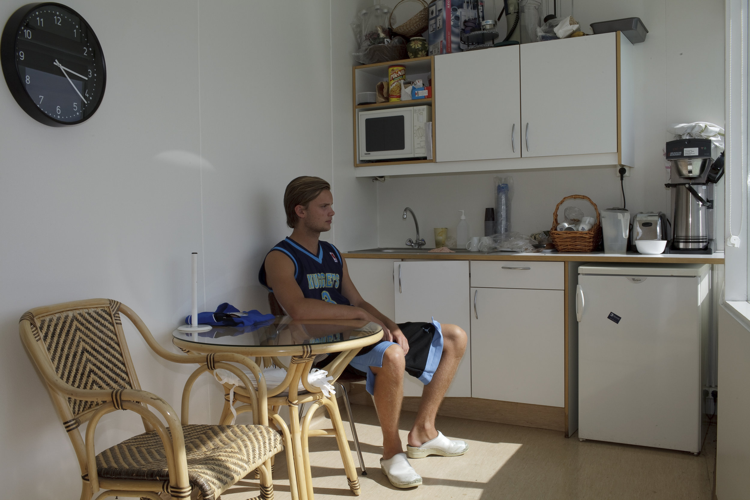  A lifeguard sits in the break room at the local pool in Hveragerði. 