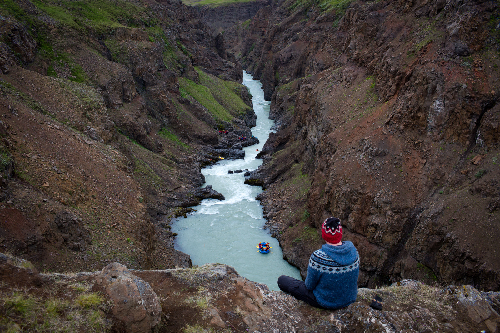  The bus driver for Viking Rafting watches a rafting group from a cliff just before they pass through a rapid on the East Glacial River. 