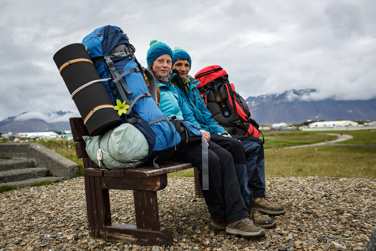 Two Polish backpackers hitch hiking their way across Iceland take a break on a bench in Hofn in southeastern Iceland. 