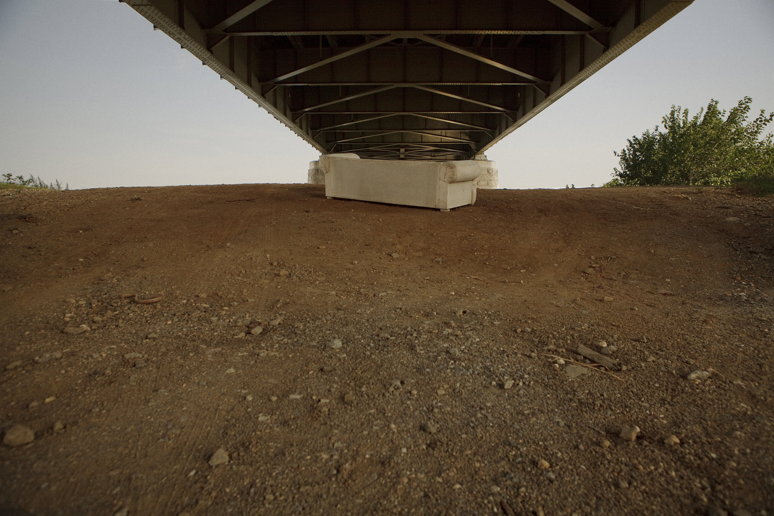  An abandoned couch sits under the Frederick Douglass bridge, east of the river, just across the water from Nationals Stadium. There is a growing gap between development and neglected space in many parts of southeast. 