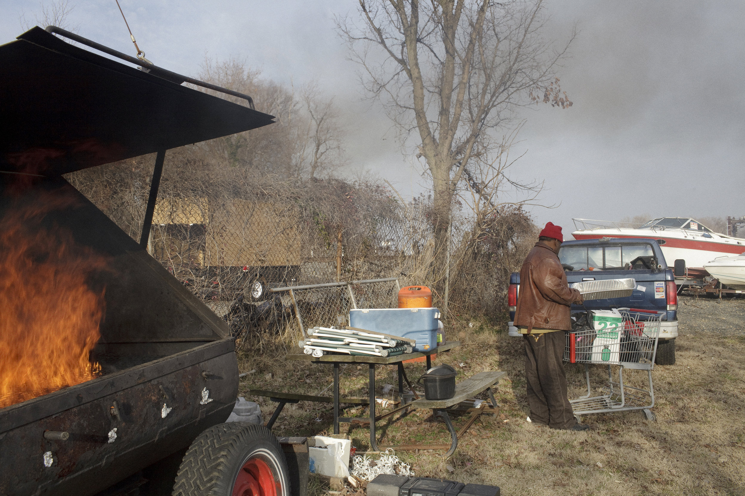  A.J., a member of Seafarers Yacht Club, the first Historically Black Yacht Club in the District, fires up the grill to cook a recently caught catfish. 