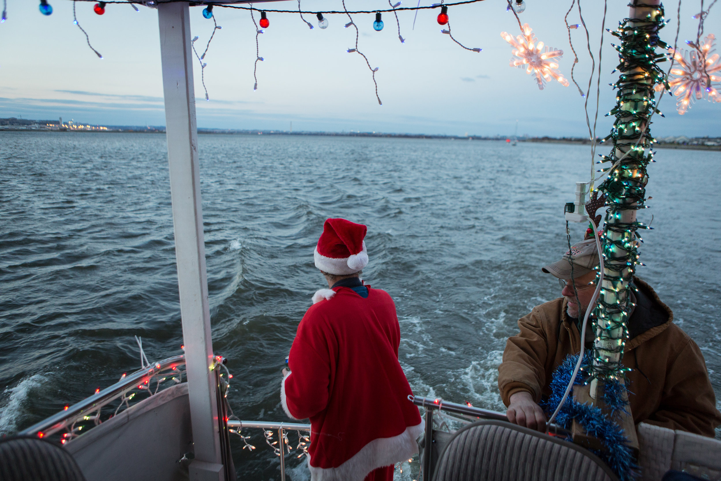 Greg Drenter, the commodore of the Eastern Power Boat Club, which is situated on the Anacostia River, rides in the parade of lights, an annual boat decorating competition.