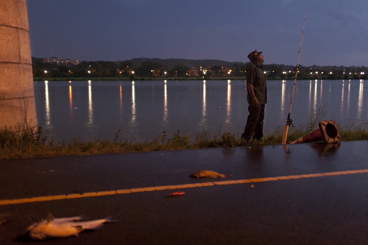 Ed fishes under the John Philip Sousa bridge on a Friday night in June, 2012.