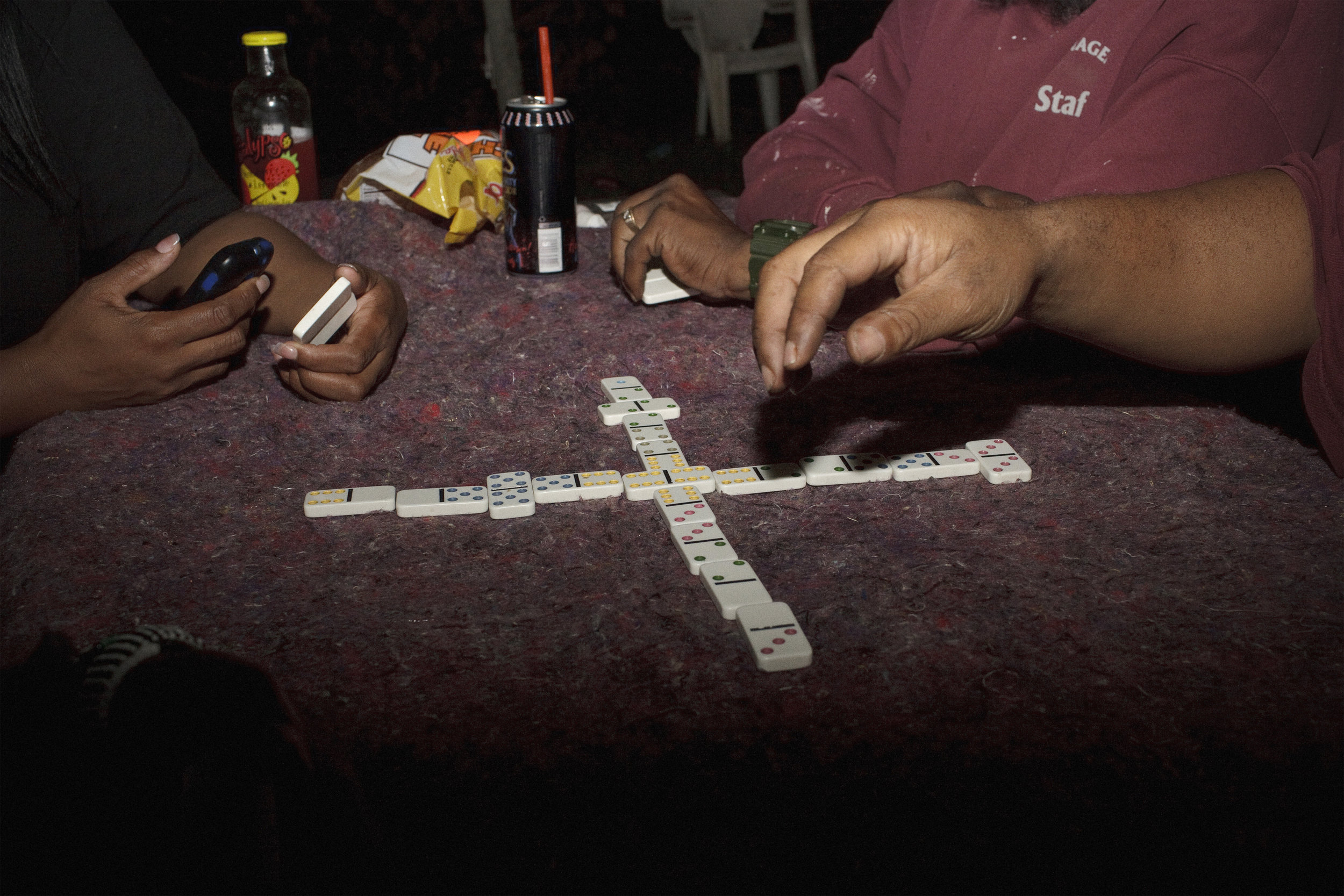  A group of friends spends time hanging out, listening to music, and playing dominos, near the Sousa bridge on the west side of the Anacostia River. 