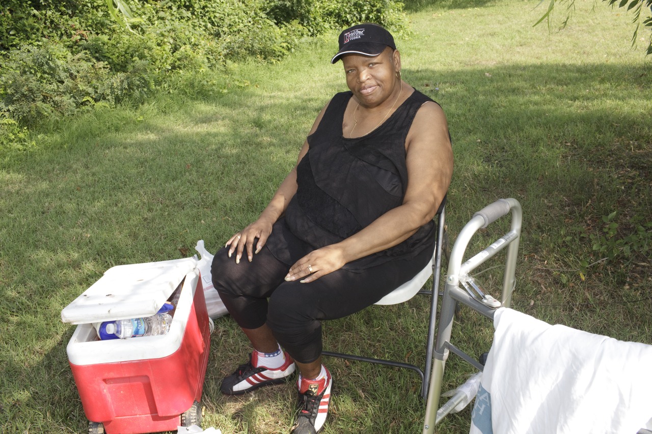  Gail Halfacre sits with her husband Kojak while he fished for blue cats from the Anacostia in August 2012.  
