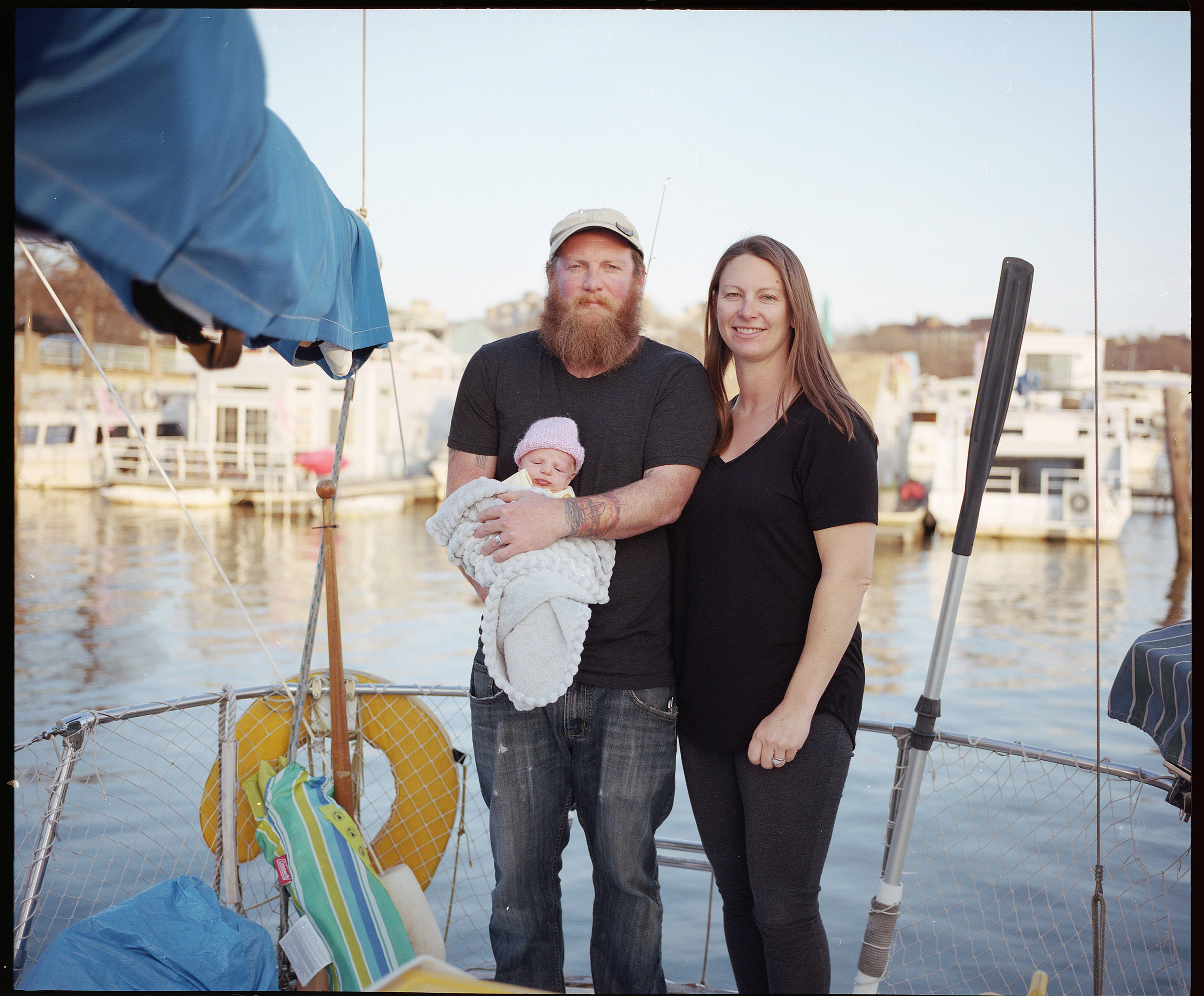   Greg Whittier, Aubrey Andre and their then 17-day-old daughter Rue Constance aboard their sailboat Tenalach.  “Gangplank is a family,” says Andre. “Now we have an almost 5 month old baby, and she has been held and cared for by many neighbors. This 