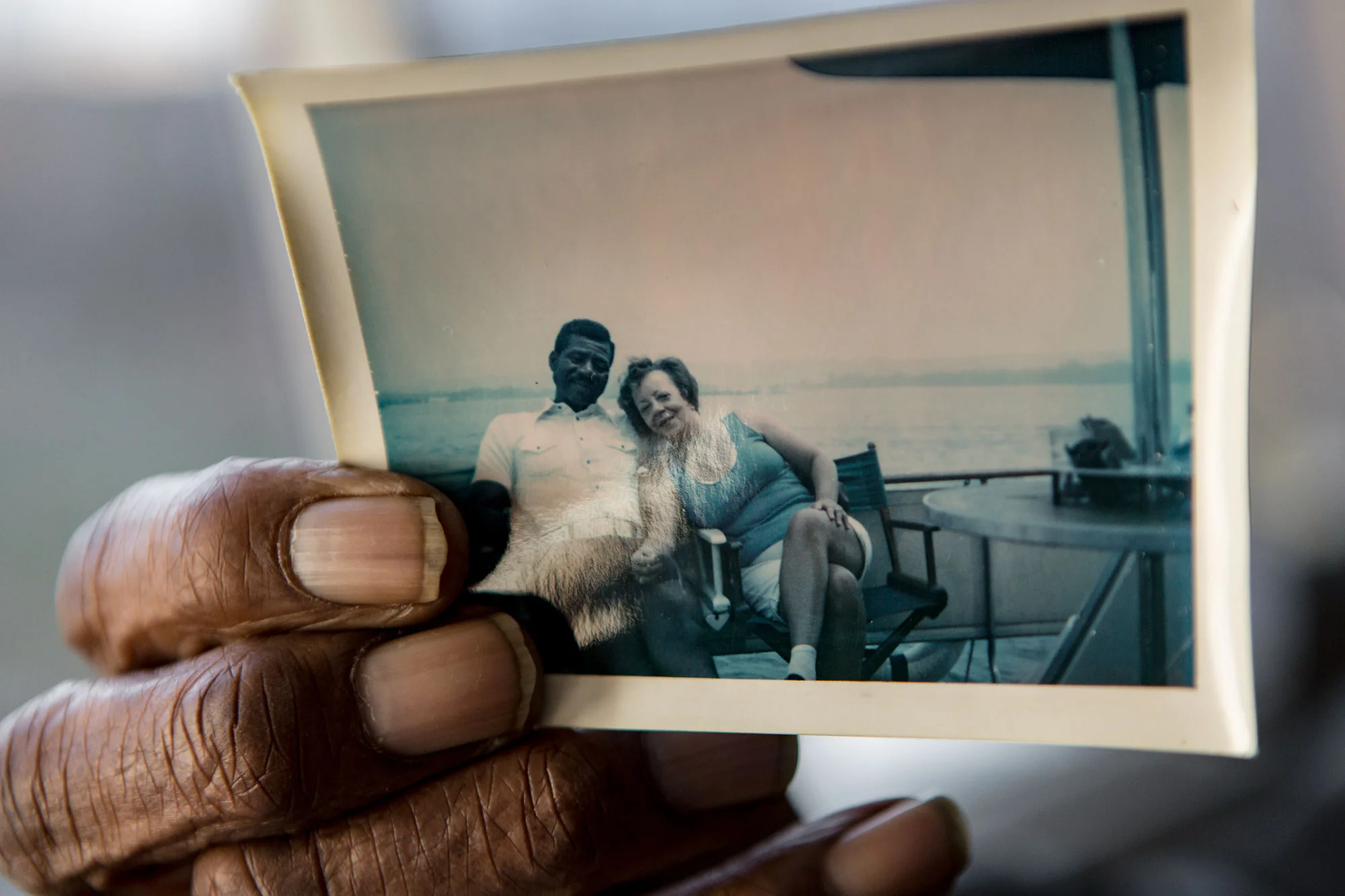 Charles "Bob" Martin, 87, holds a photograph of himself with his late wife Natatchia. Martin has named four of his boats after her.