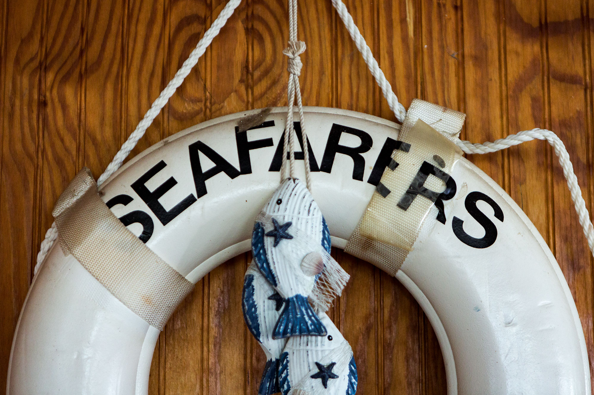  A life preserver bearing Seafarers' name hangs on the wood-paneled wall of the clubhouse. 