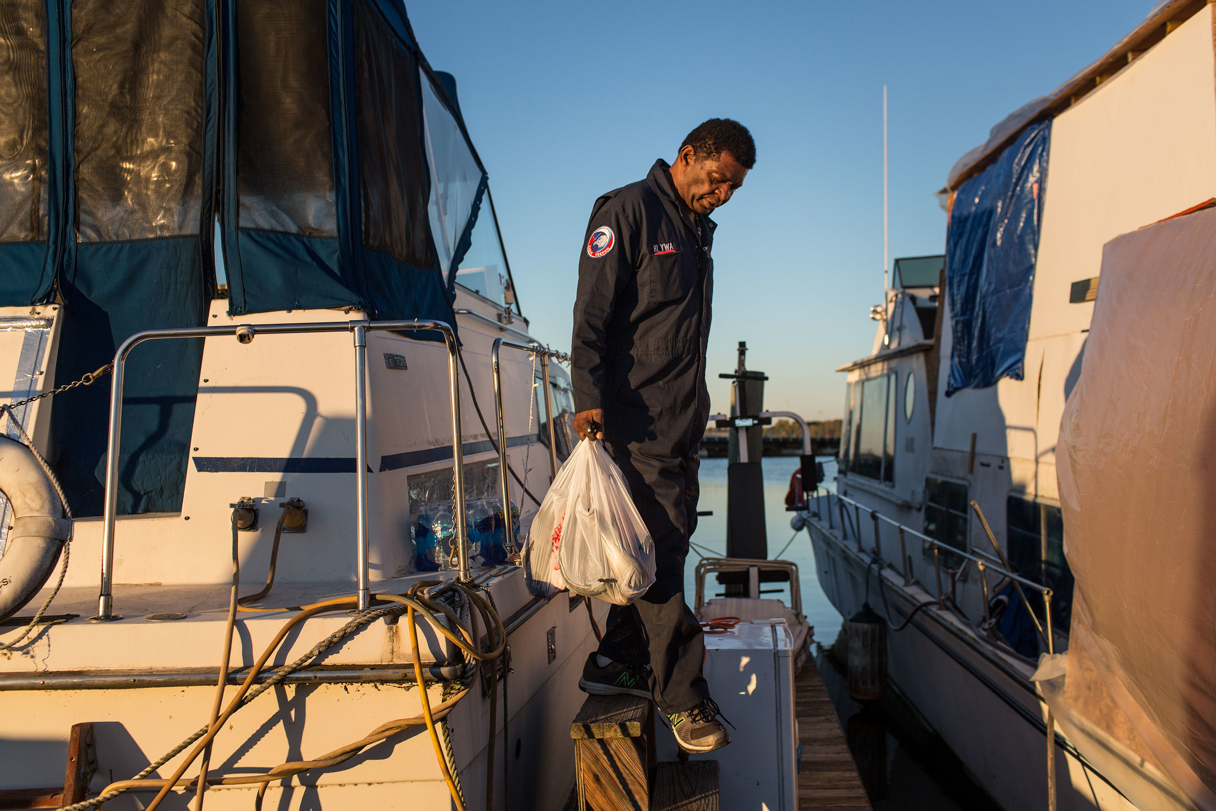  AJ Hall carries fish he caught from his boat,  The Raven . 