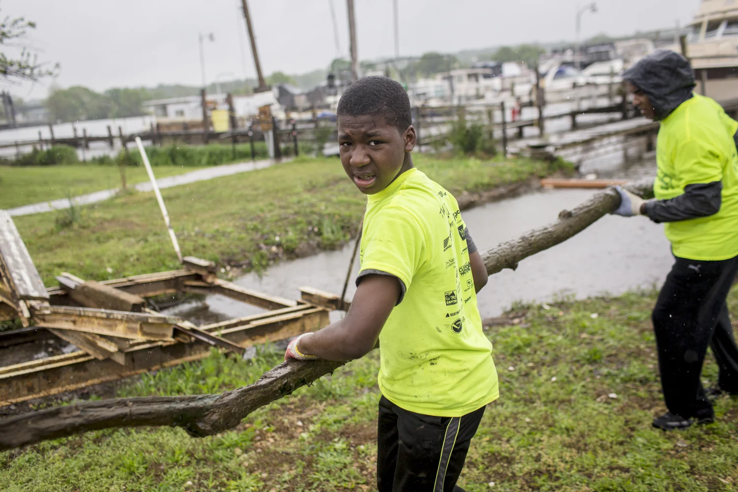Shamaari Pondexter, a mentee in the "Just Say Yes" program cleans up driftwood at the annual Earth Day clean up in 2016.