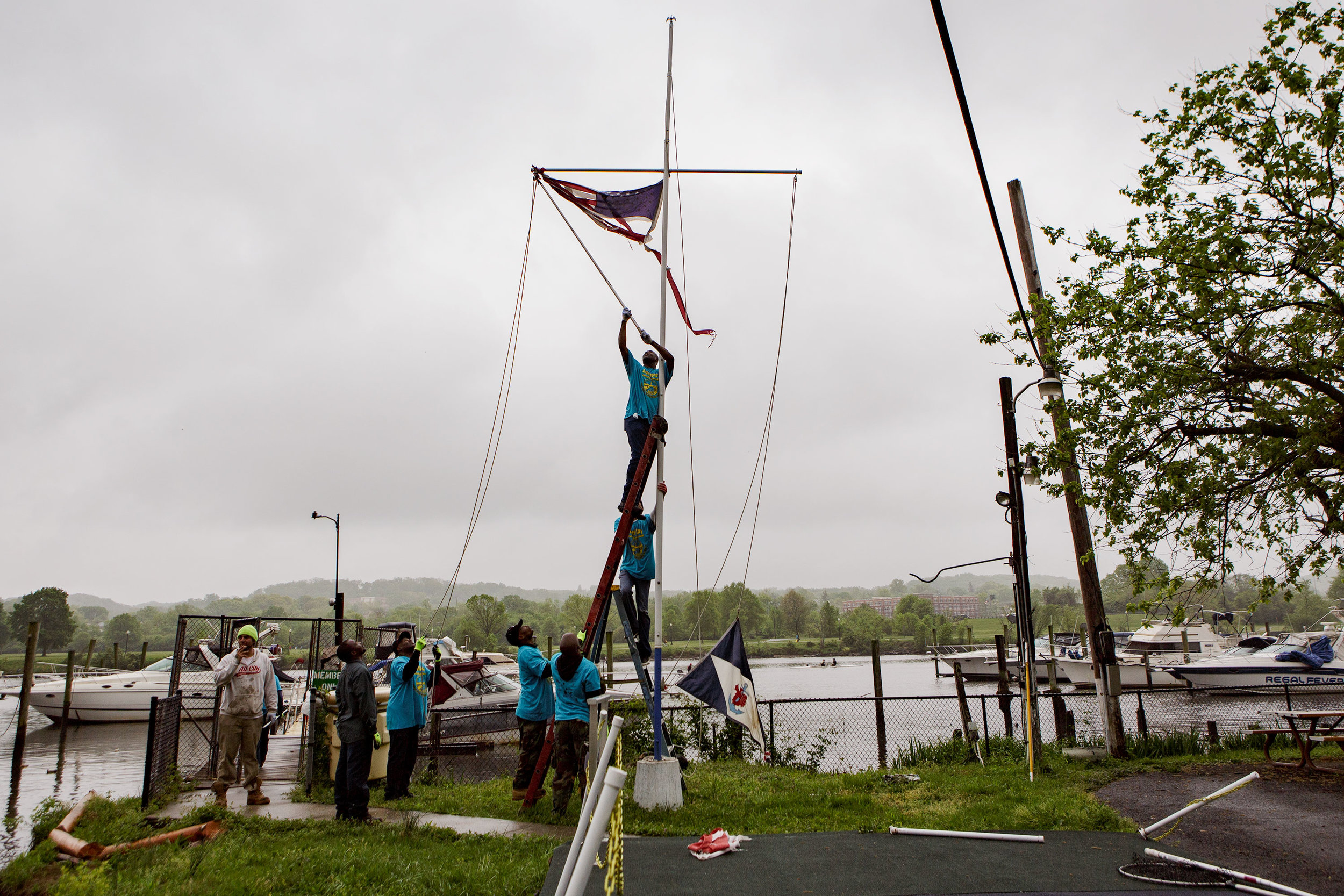  Seafarers' members work together to take down a wind-tattered American flag on Earth Day, 2017. 