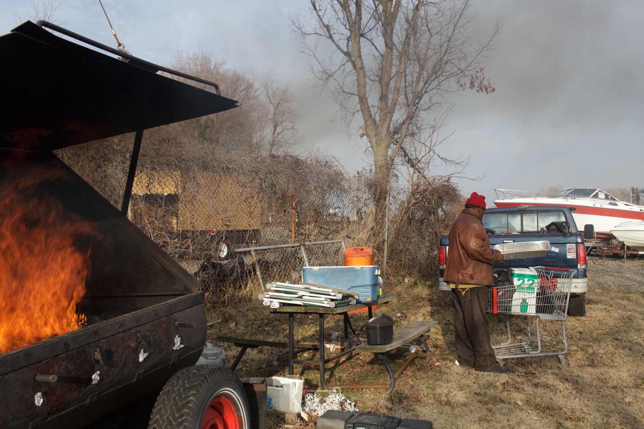  AJ prepares to cook a catfish he caught on the Anacostia on the grill at Seafarers.  