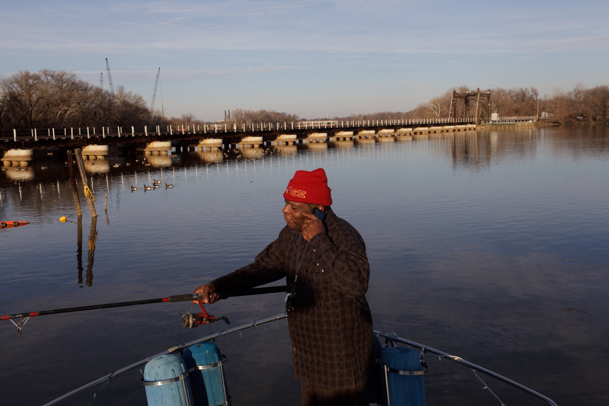 AJ Hall, fishes from his boat, The Raven, which is docked at Seafarers Yacht Club on the Anacostia. The tide was too low to go out on the water, and he did not catch a fish until it came in.