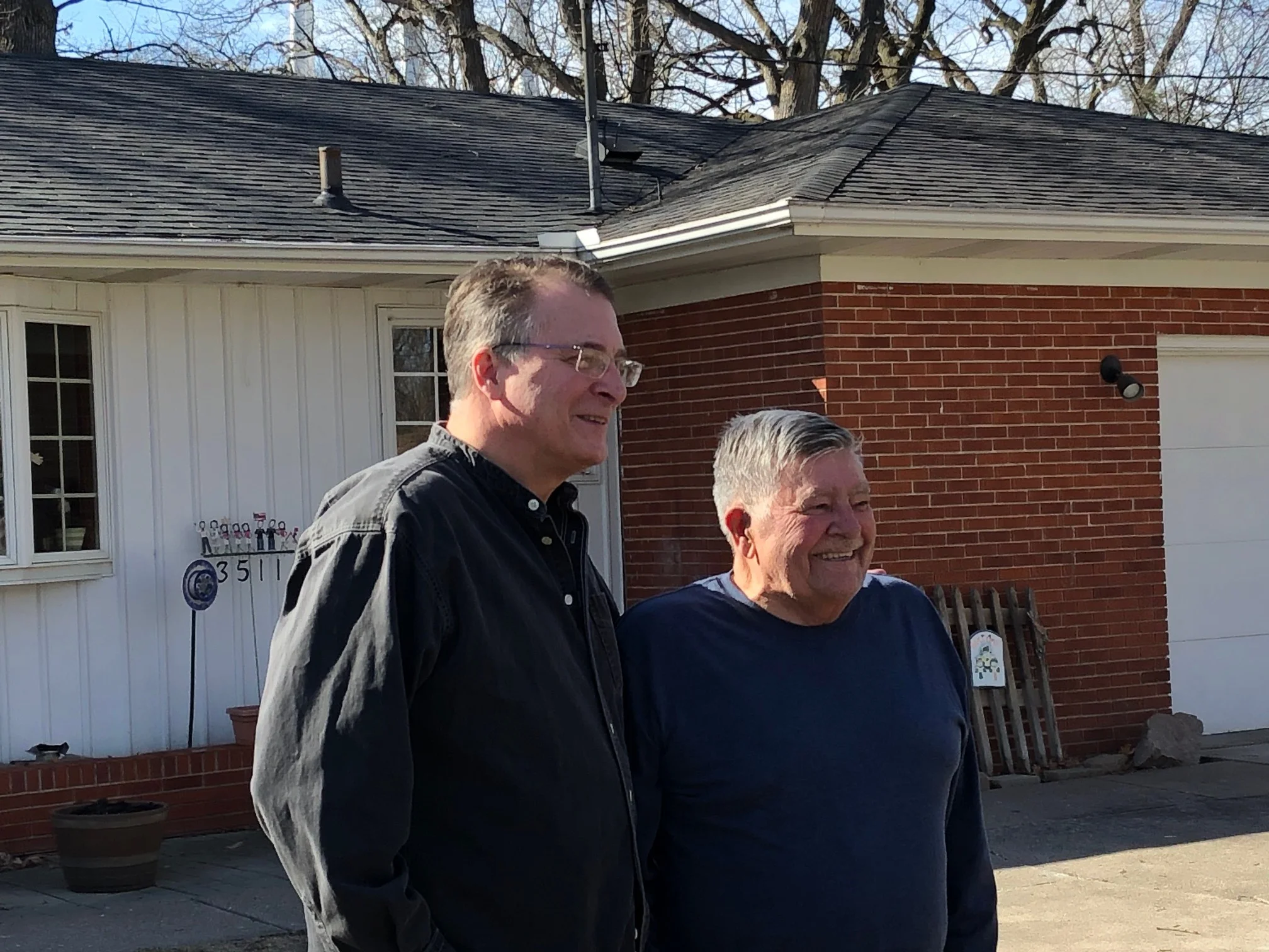 Mike Jacobs joins his father, Denny Jacobs, both former state senators, outside his home in East Moline. (One Illinois/Ted Cox)