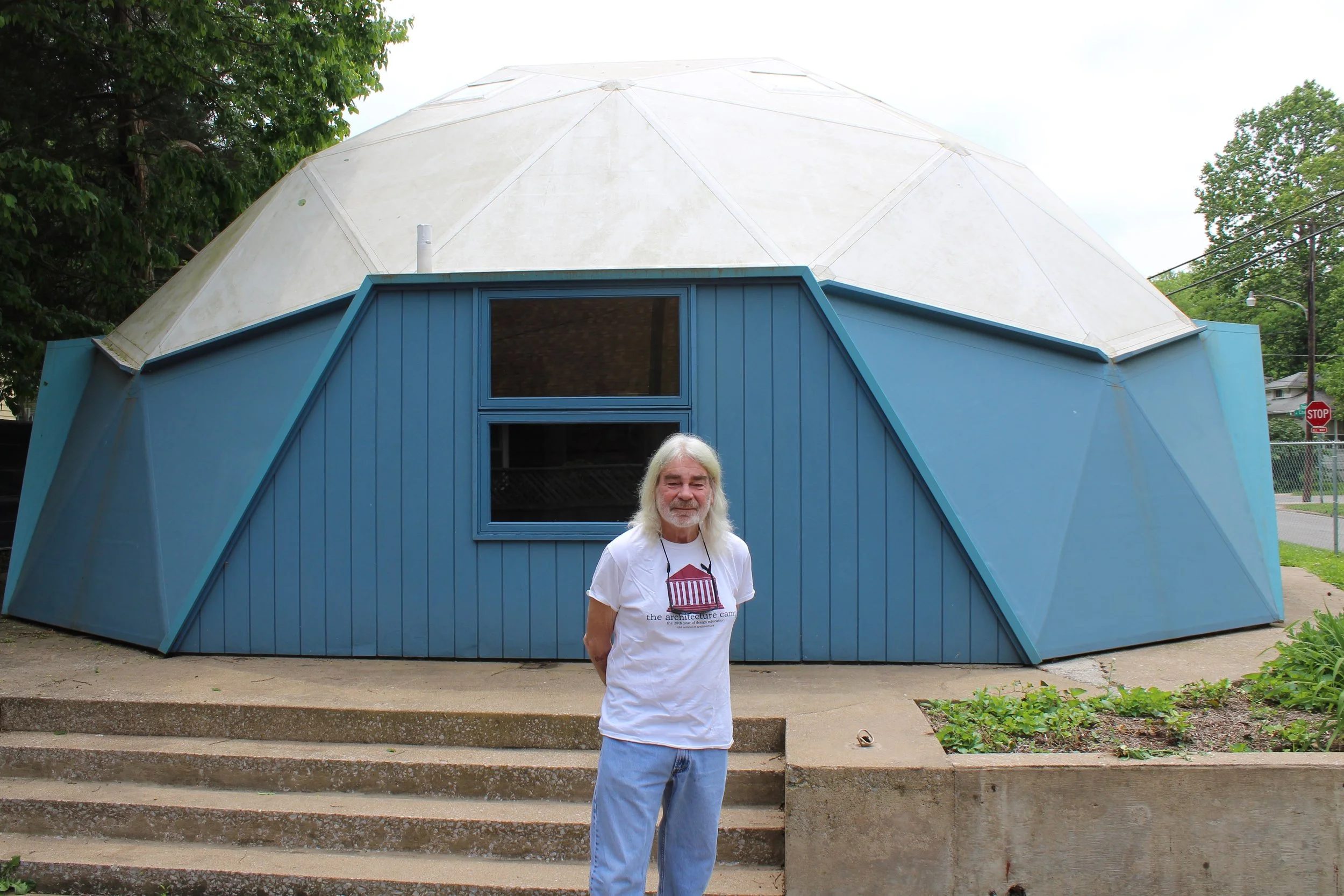 Jon Davey, SIU architecture professor, stands outside the geodesic dome that Buckminster Fuller lived in as his home in the '60s. (One Illinois/Ted Cox)
