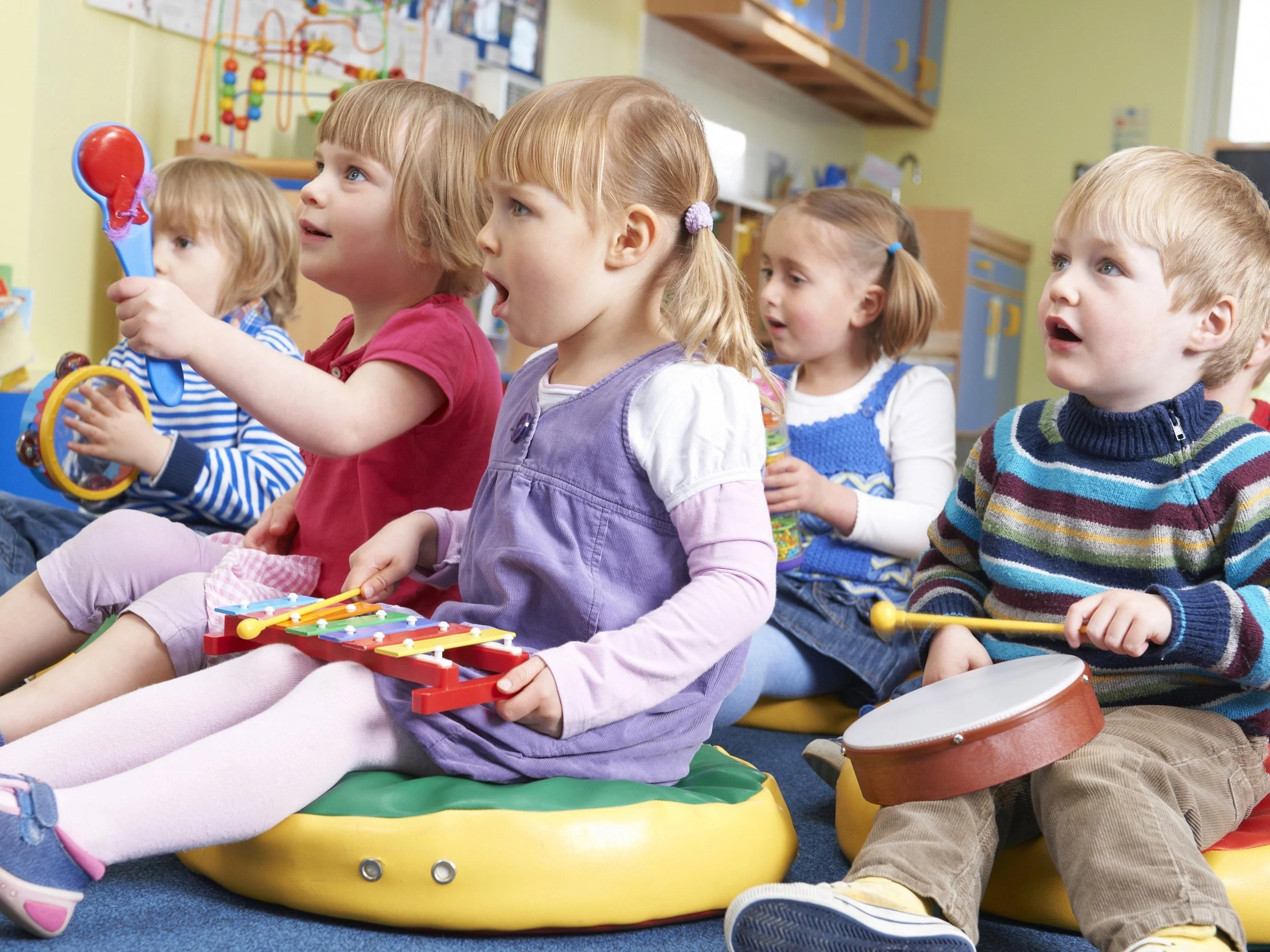Students learn to play musical instruments in a preschool class. (Shutterstock)