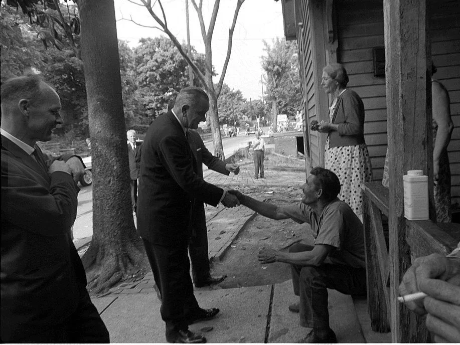 President Lyndon Johnson shakes hands with a farmer on a rural poverty tour in the '60s. (Wikimedia Commons/Cecil Stoughton)