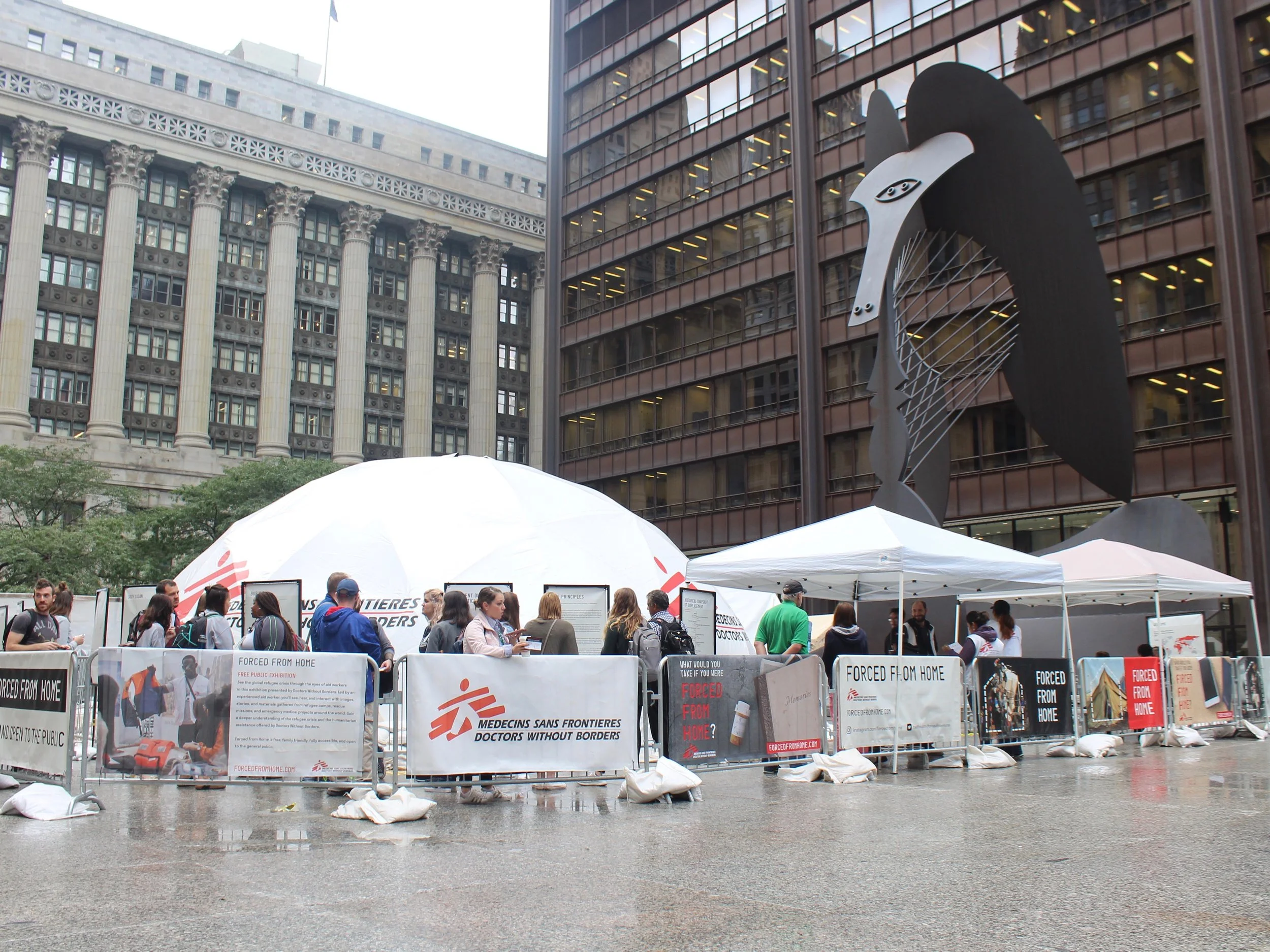 The Doctors Without Borders traveling exhibit “Forced From Home” has been set up in Chicago’s Daley Plaza at the base of the Picasso sculpture. (One Illinois/Ted Cox)