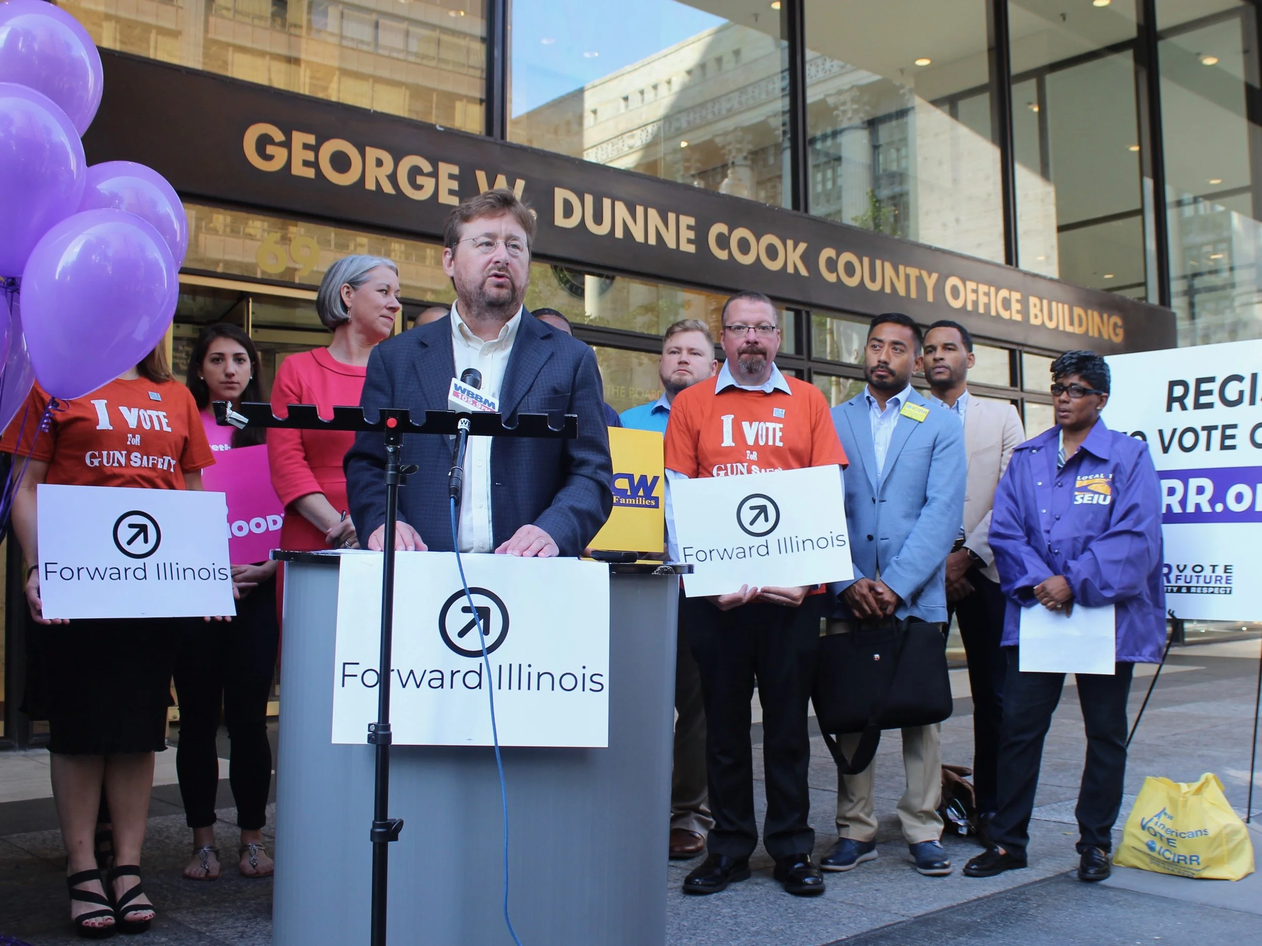 Jennifer Welch of Planned Parenthood Illinois, Jack Darin of Sierra Club Illinois, and Mike Ziri of Equality Illinois (from left, with Darin at podium) announce the Forward Illinois launch last month. (One Illinois/Ted Cox)