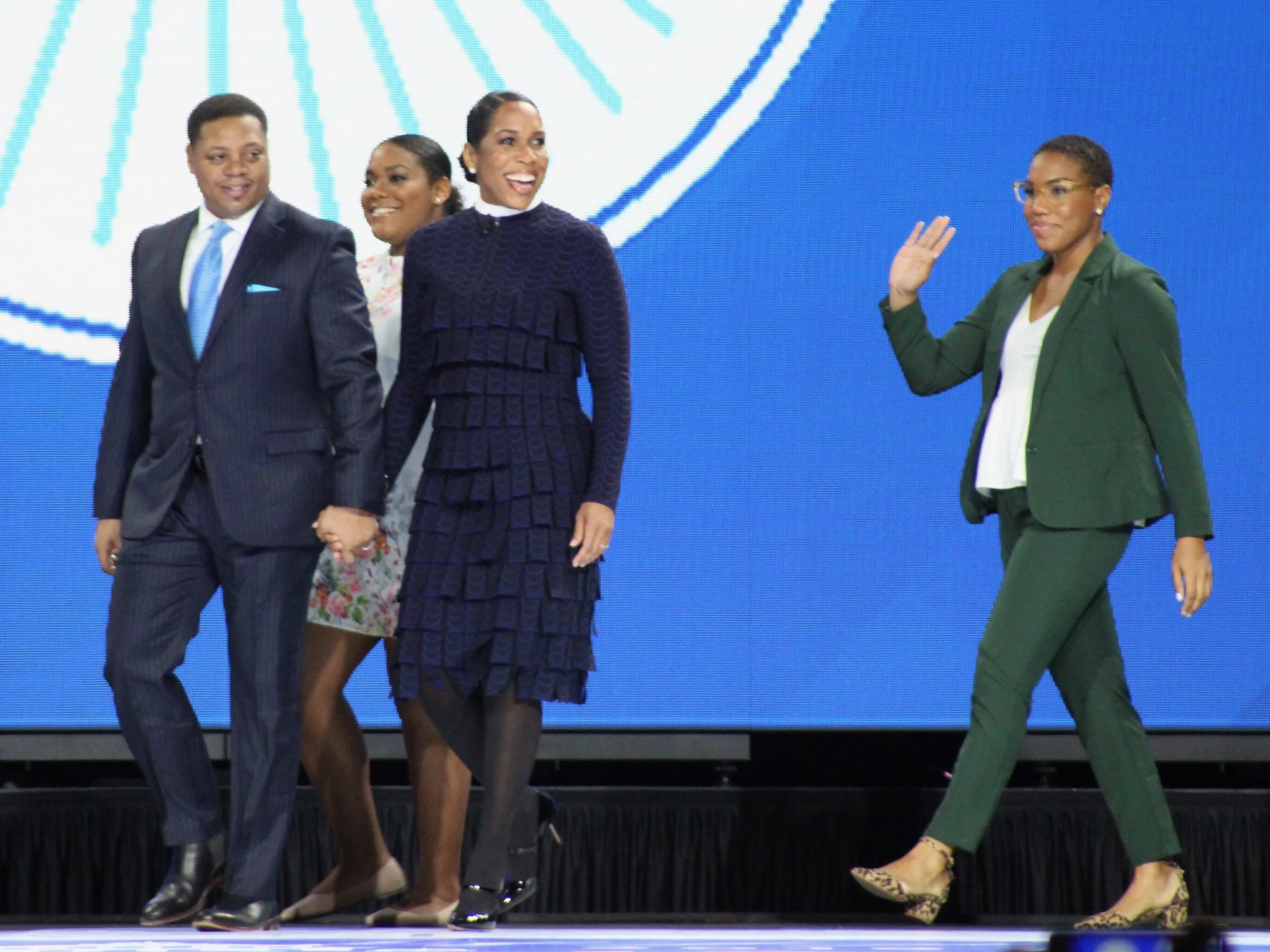 Holding the hand of fiancee Bryon Echols, Juliana Stratton takes the stage at the Illinois inauguration ceremony Monday along with two of her daughters. (One Illinois/Ted Cox)