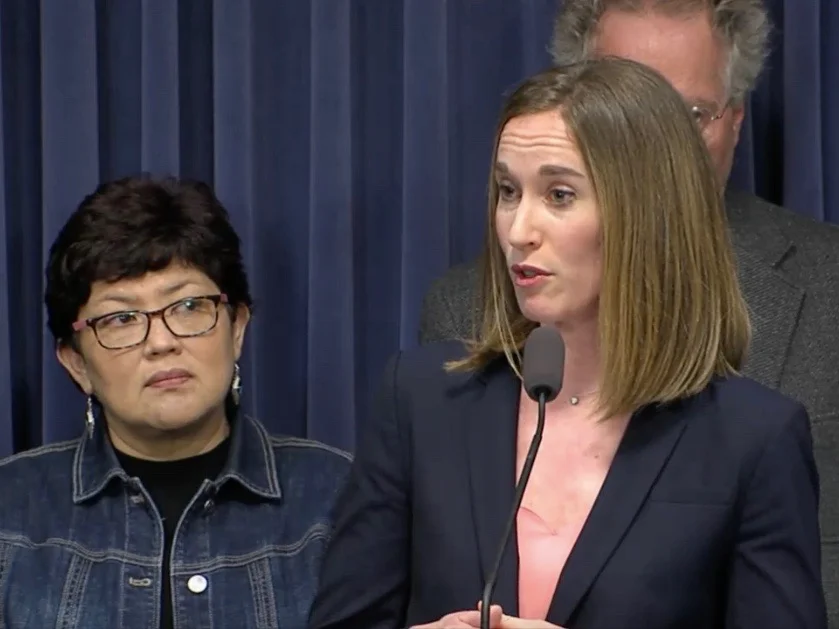 Backed by Imelda Salazar of Chicago, Allison Clements of the Illinois Housing Council makes a case for increased funding for affordable housing. (Blue Room Stream)