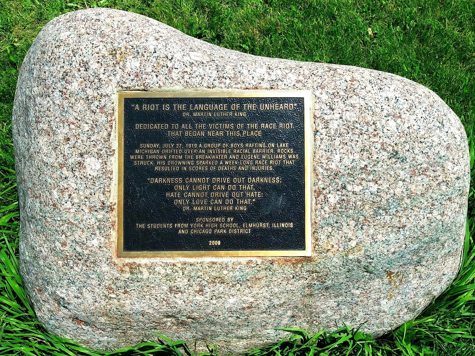 A plaque mounted on a stone near the site of Eugene Williams’s murder by drowning, which ignited the 1919 Chicago race riots. (Flickr/Stephen Hogan)