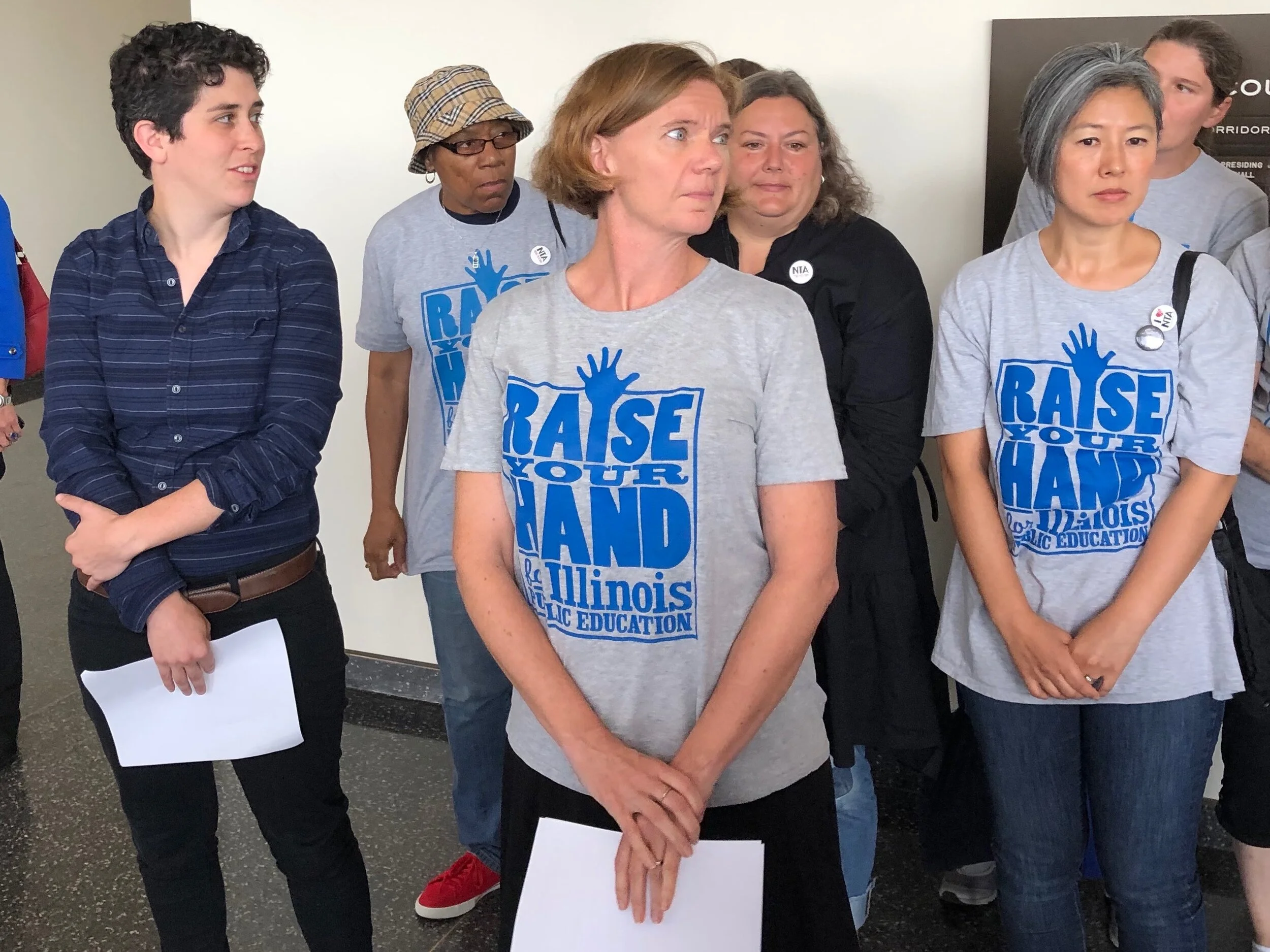 Timna Axel (left) and Jennie Biggs (center) prepare to address the media after Wednesday’s court hearing. (One Illinois/Ted Cox)