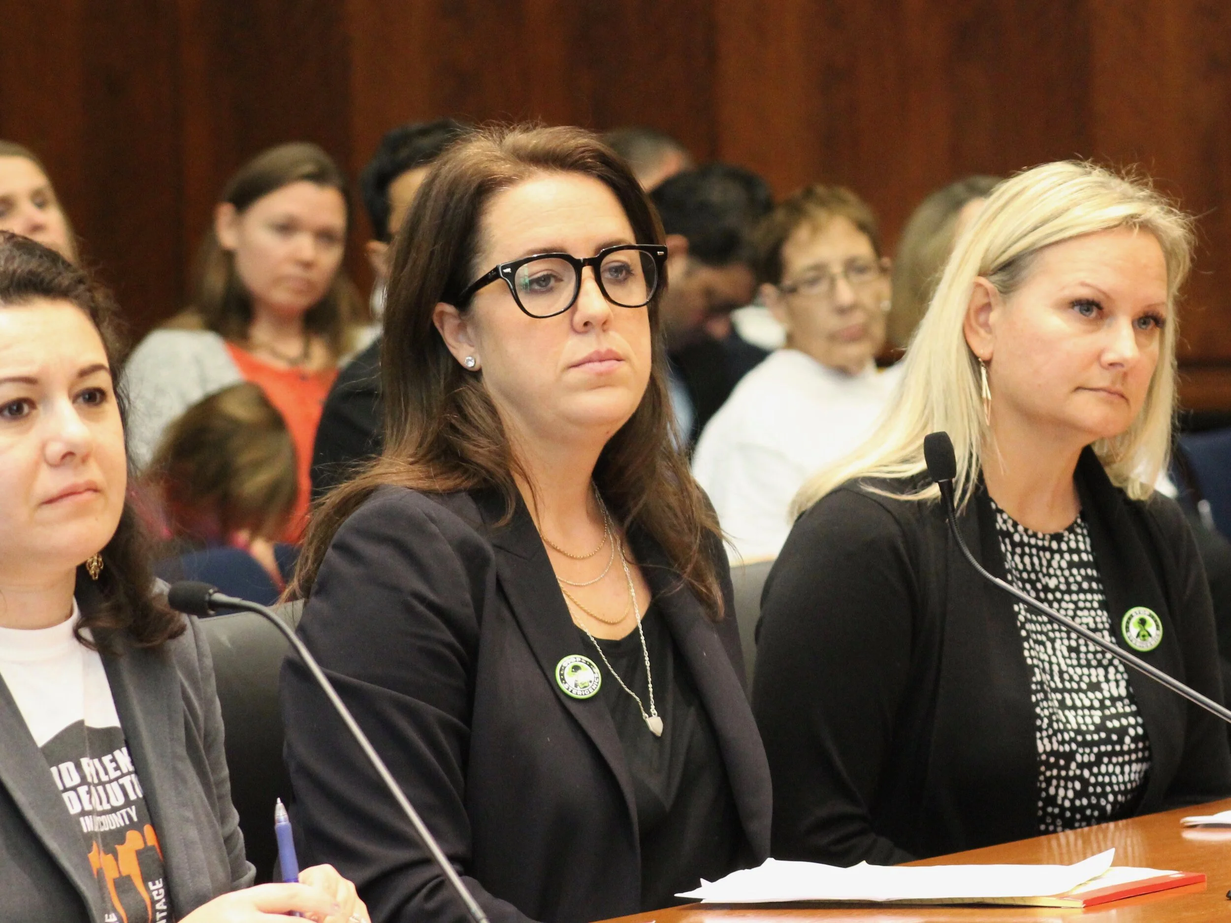 Tea Tanaka, Lauren Kaeseberg, and Margaret Donnell prepare to testify before Thursday’s House committee hearing. (One Illinois/Ted Cox)