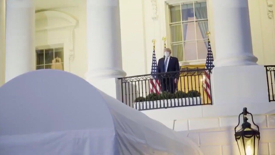 A masked President Trump returns to the White House Monday evening after being hospitalized for COVID-19. He soon tore the mask off — and reversed course on his support for a coronavirus relief package. (Facebook/Donald Trump)
