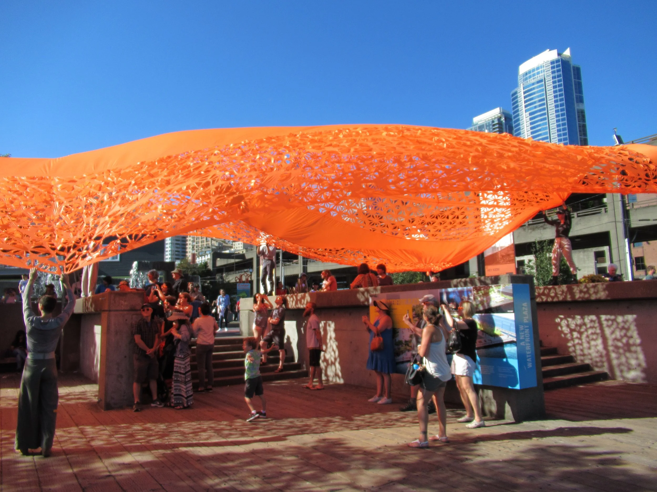 our giant orange dress floats overhead on the old waterfront of Seattle