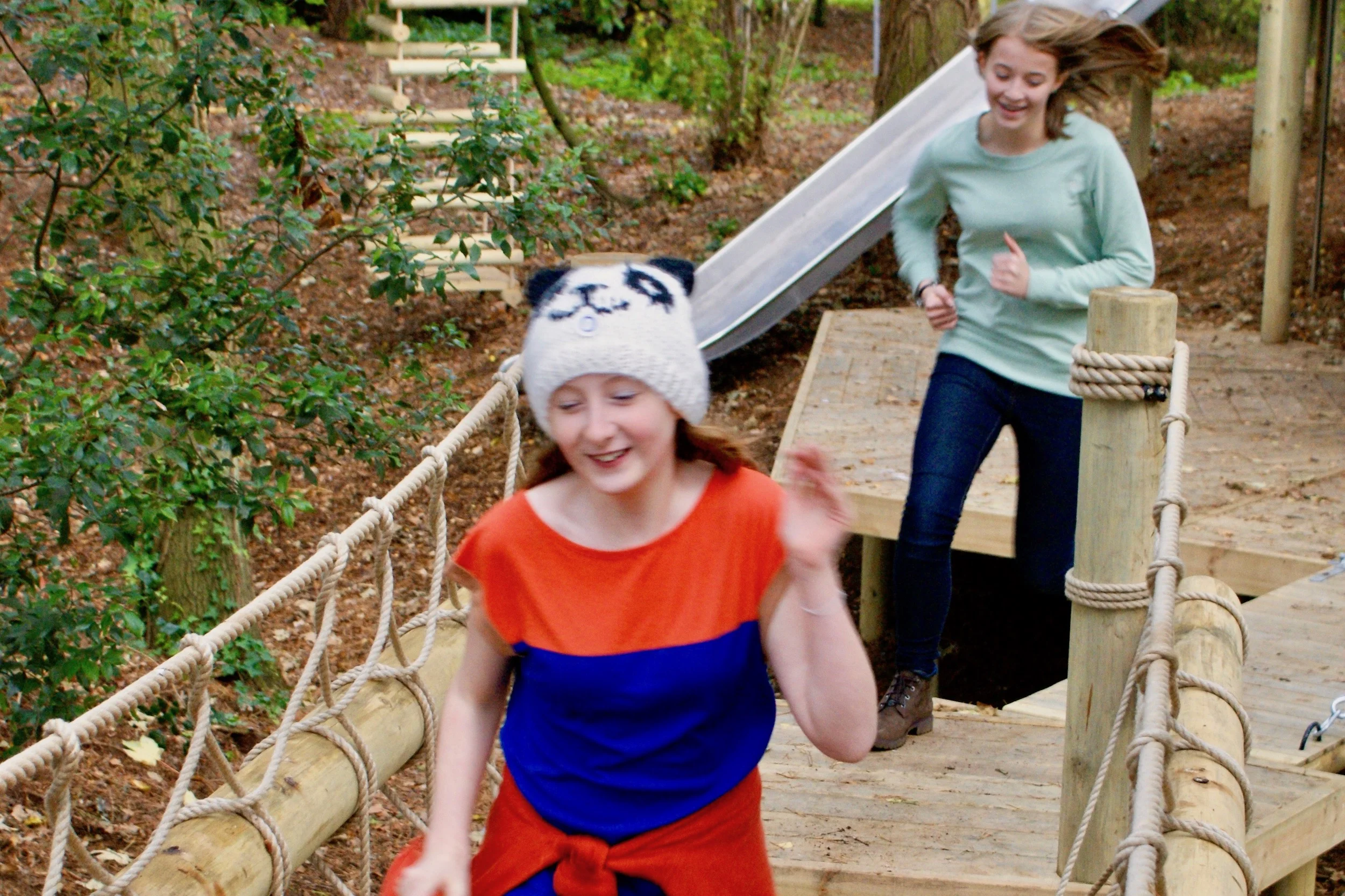Kids running across a woodland Rope Bridge