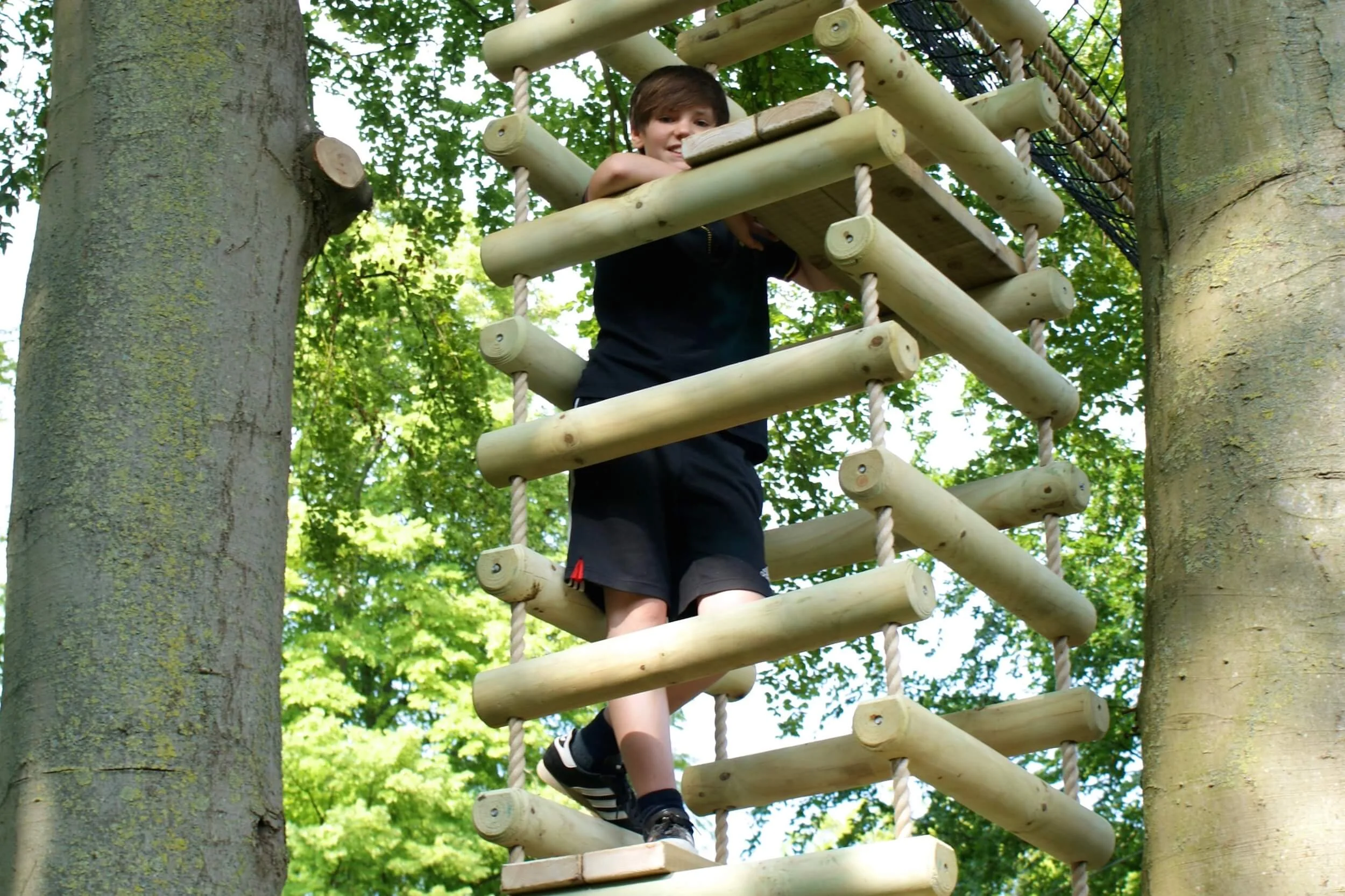 Boy standing in a 4-sided Rope Ladder