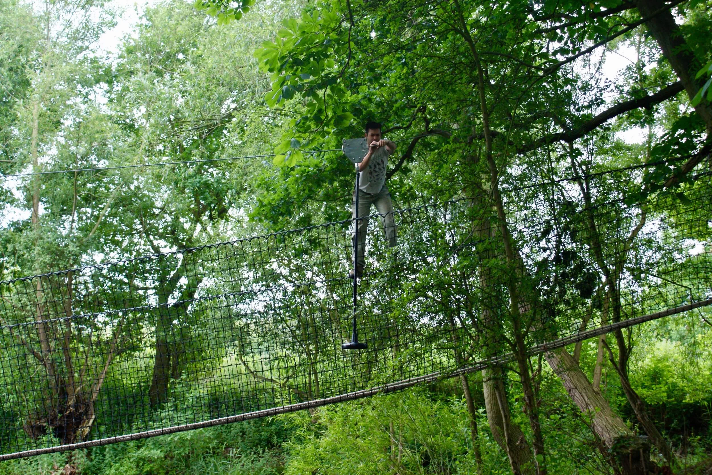 Installing the Zip Wire over the lake Hammock Bridge