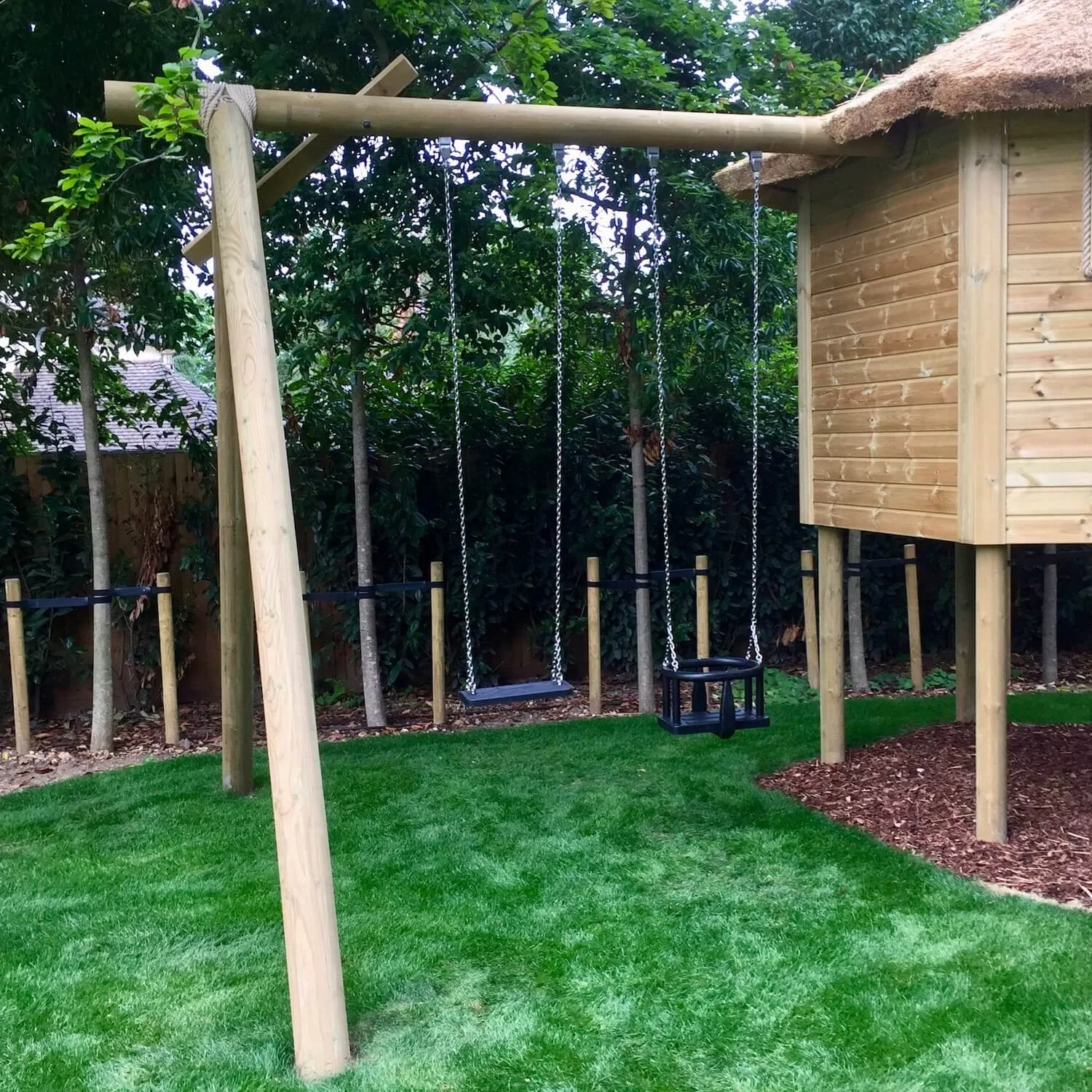 "...'A' frame swing set attached to a treehouse"