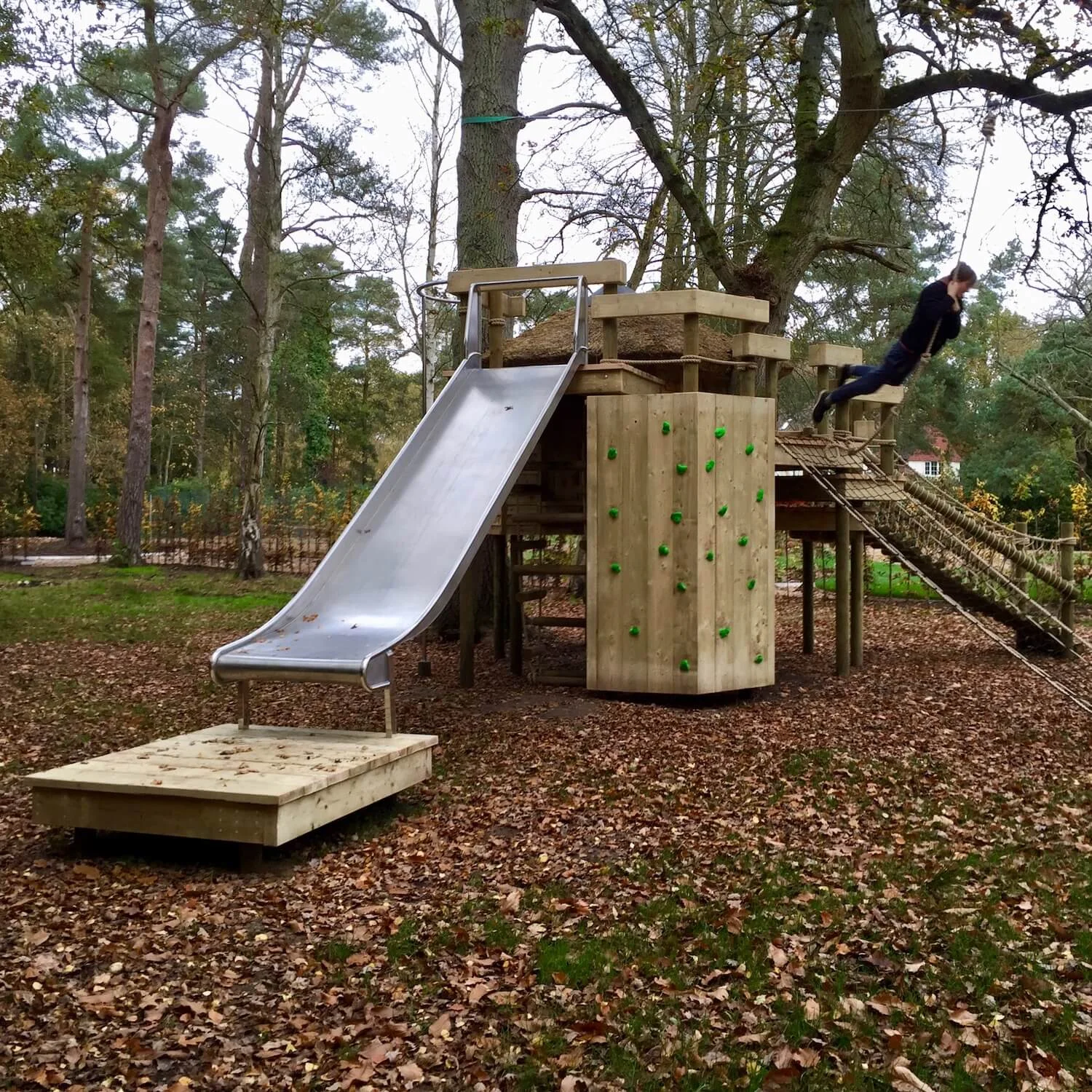 "...big double-width slide from a high treehouse deck"