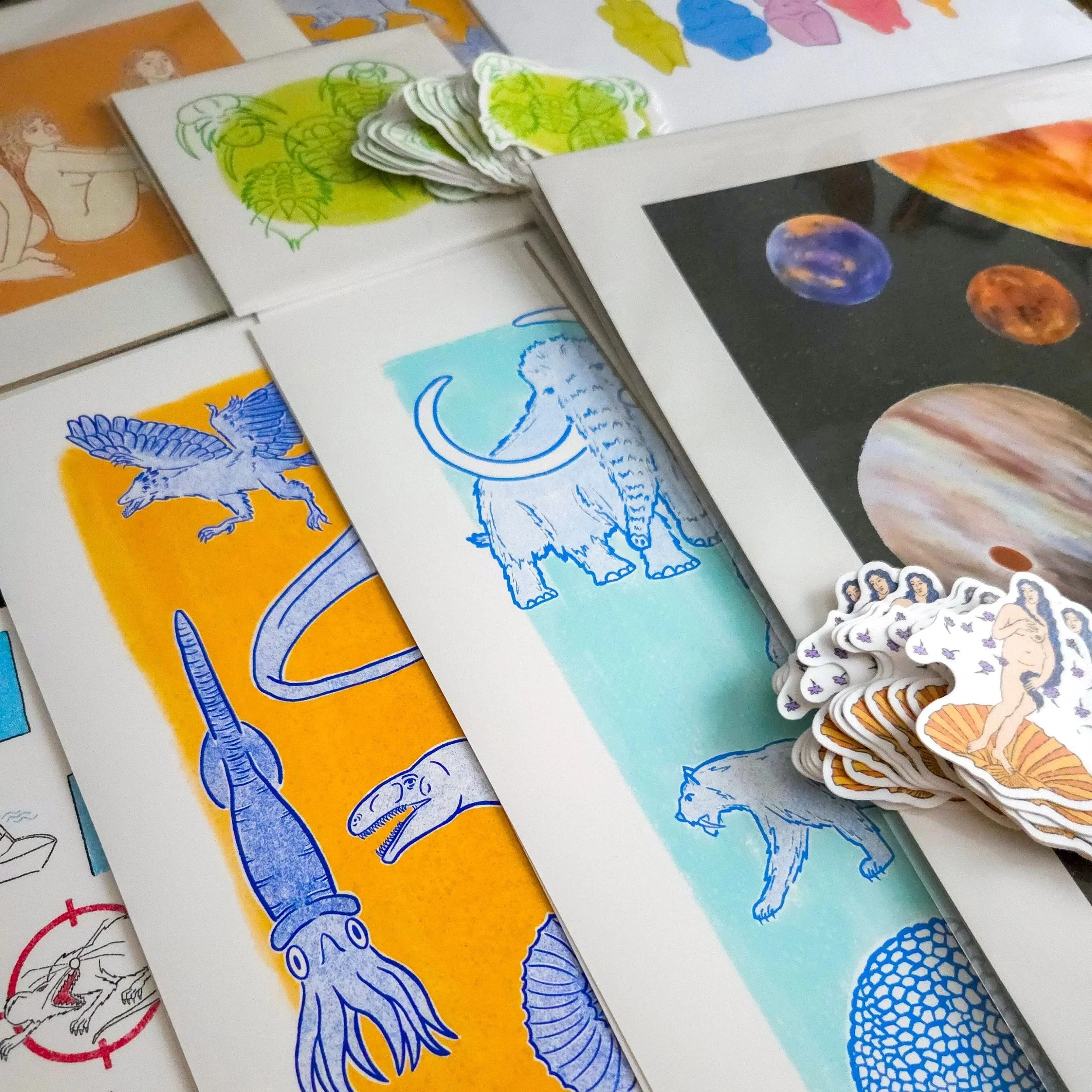 A close-up photo of illustrations and products created by Felipithecus, Madelaine Walker