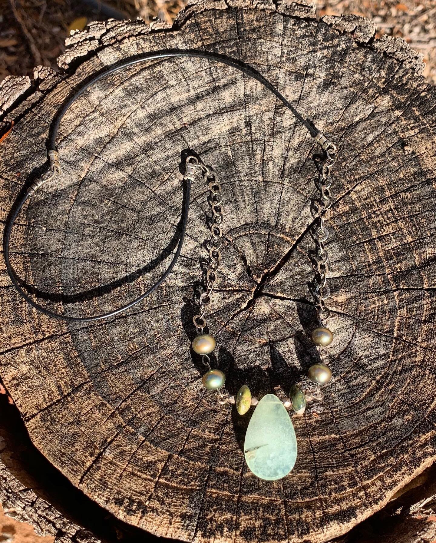 The star of this necklace is the gorgeous green Prehnite teardrop, surrounded by green natural stone beads and forest green pearls.  Sterling silver chain and black leather are the perfect additions to make a casual yet classy statement!
.
.
.
.
#nec