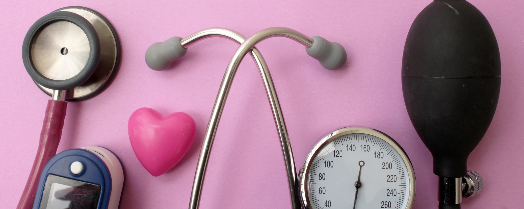 Image: Medicine concept - stethoscope, blood pressure equipment, heart and pulse oximetere on pink background