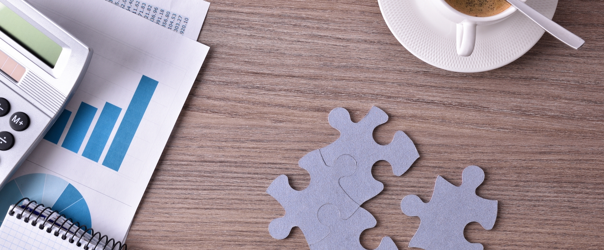Image: Representation of developing a business idea. Business table with office objects and colorful puzzle.