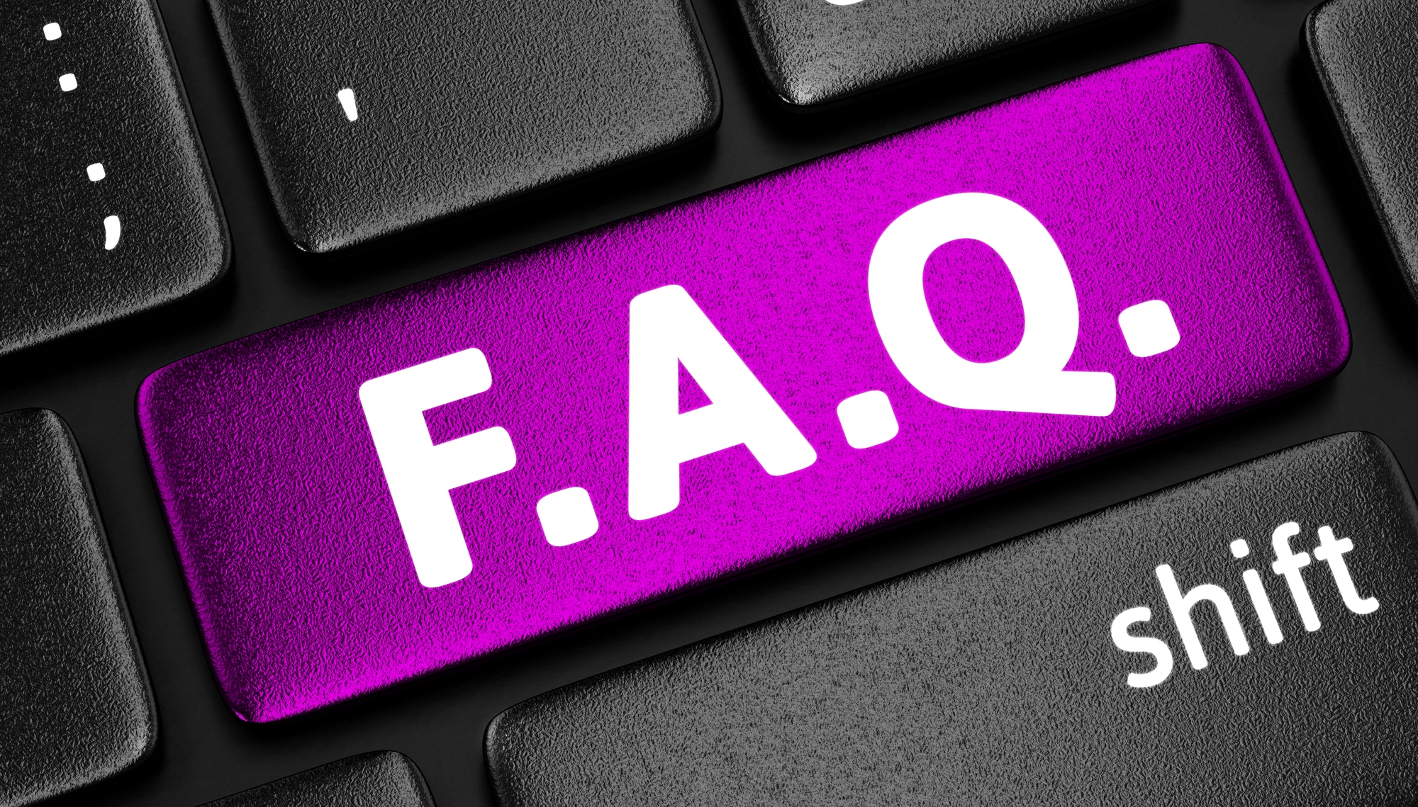 Image: A purple F. A. Q. key on a black keyboard. 