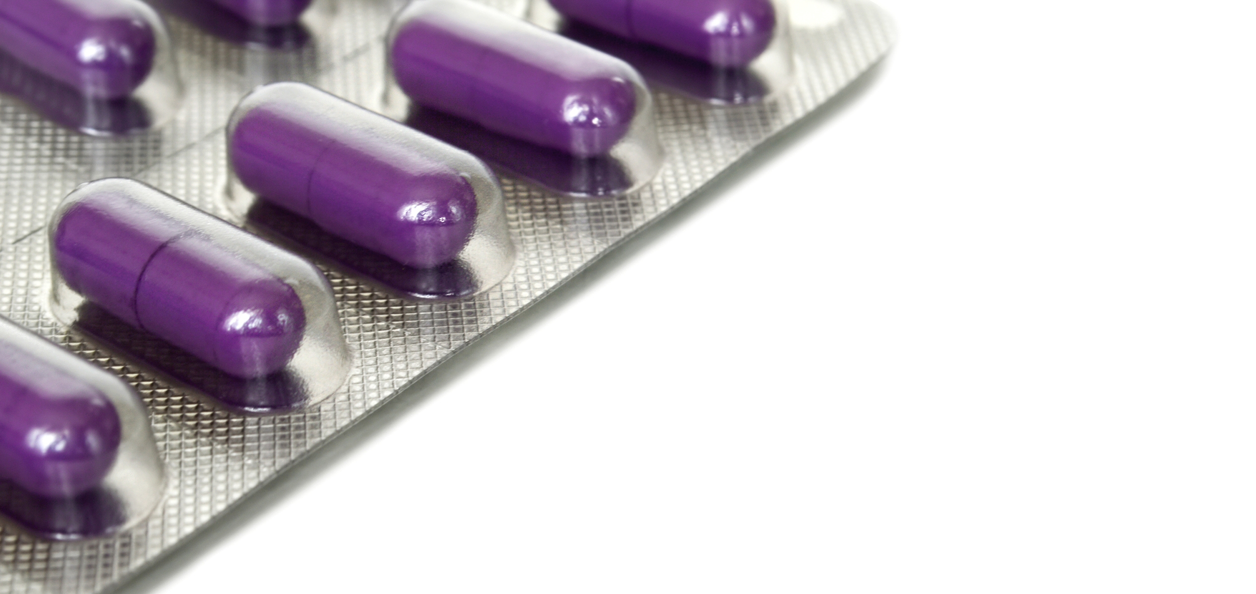 Image: A blister pack of purple oblong pills. 