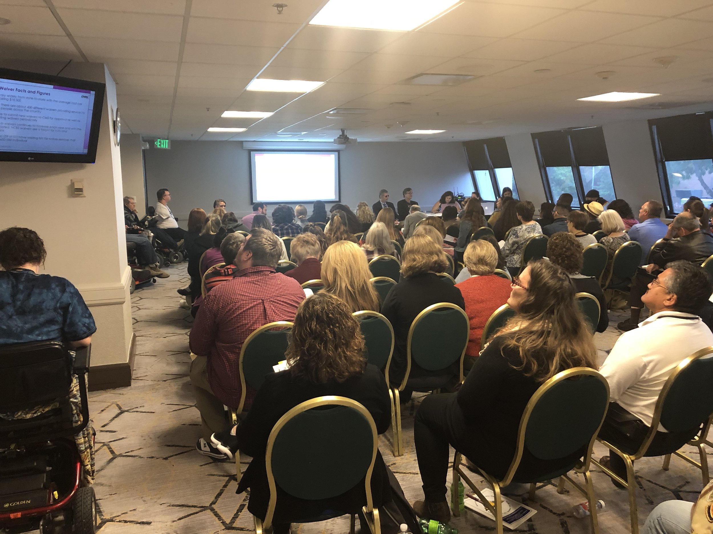 Picture: CHRIL presentation at the APRIL Conference. Picture is of a room with audience members looking toward the front of the room as CHRIL presenters speak.