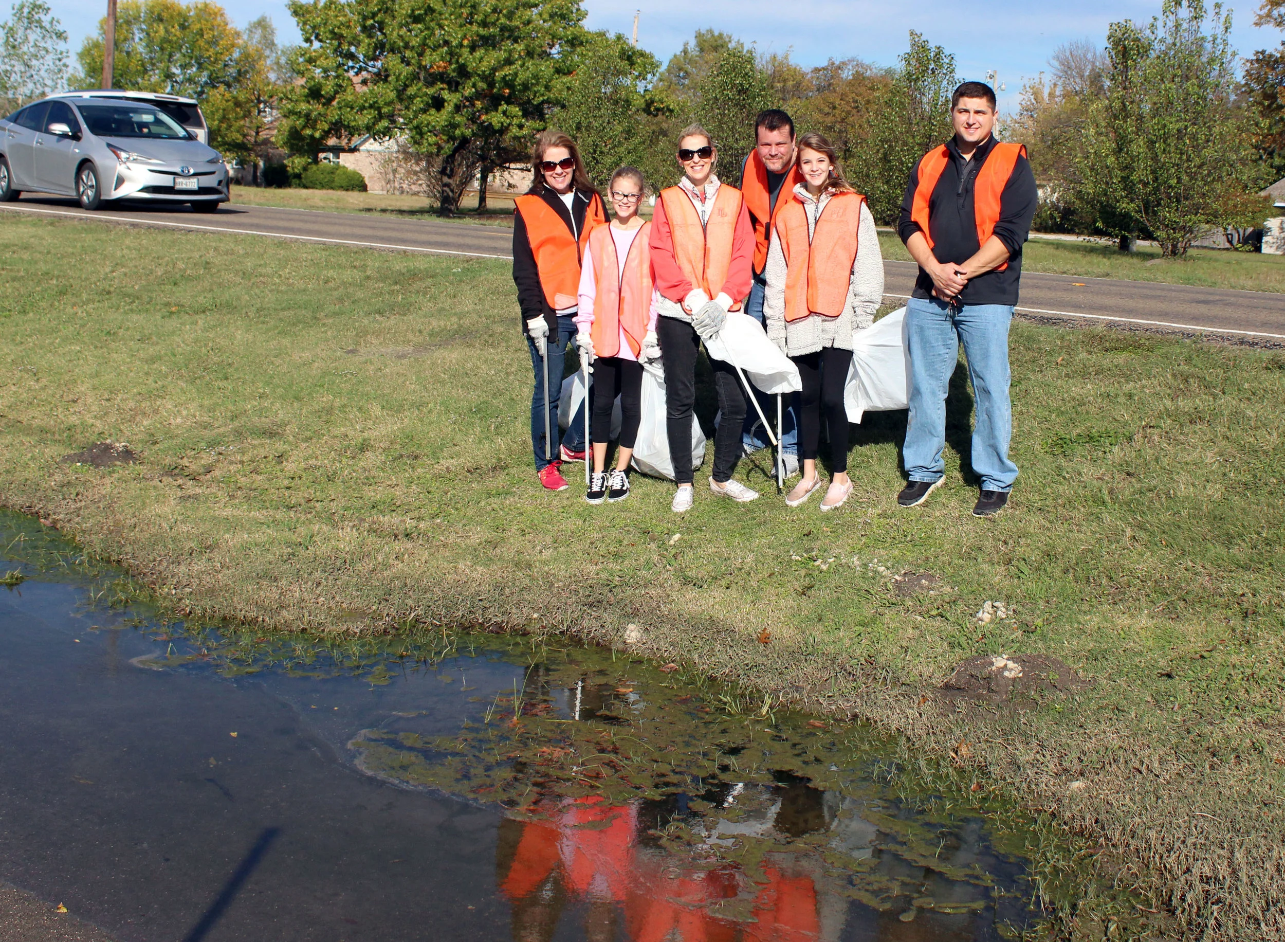 A clean-up crew worked on Estates Road in front of Grace Church. (From left) City of Lucas Parks and Open Space board member Debra Guillemaud, The Zadorozny Family – Presley, Becky, Dan and Piper and City of Lucas employee Anthony Aguinaga.