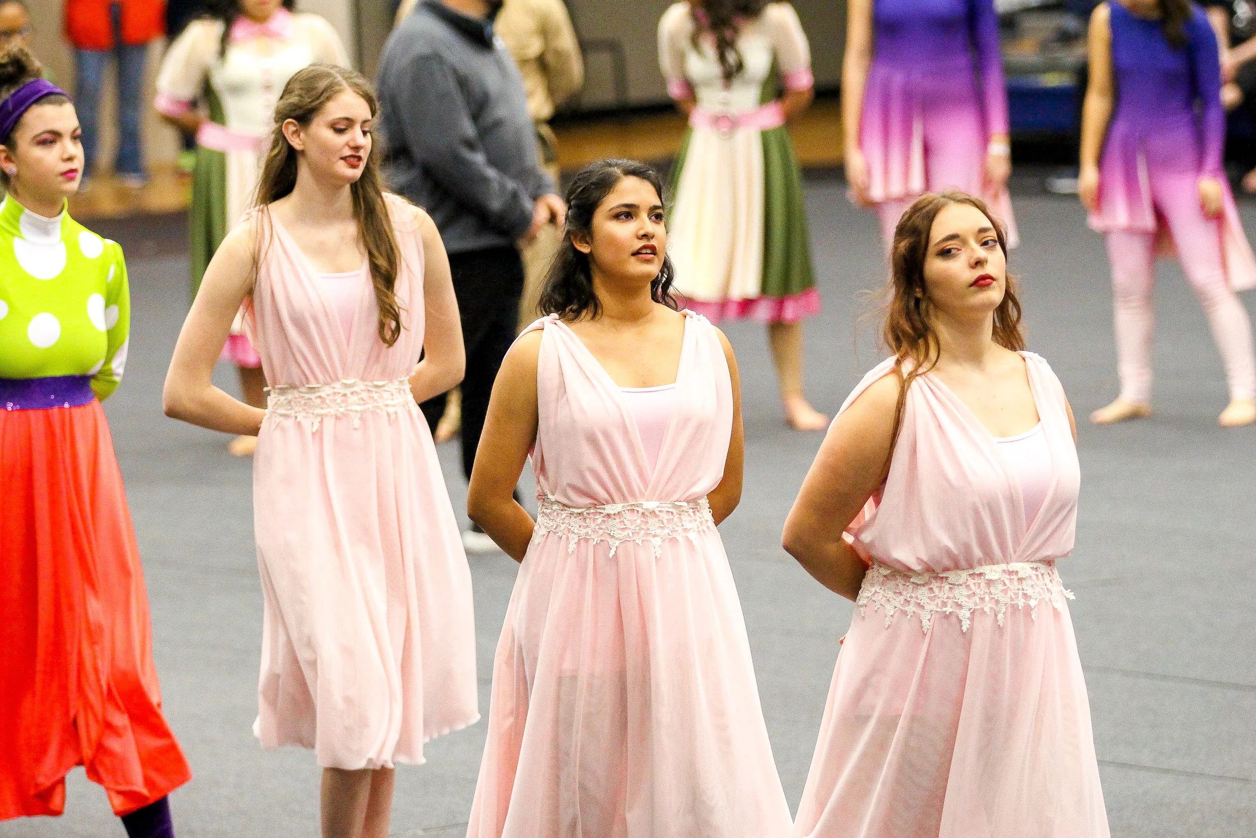 Color Guard members Isabel Marsden, Riddhi Pareek, and Aubrey Huguley walk into the award ceremony.