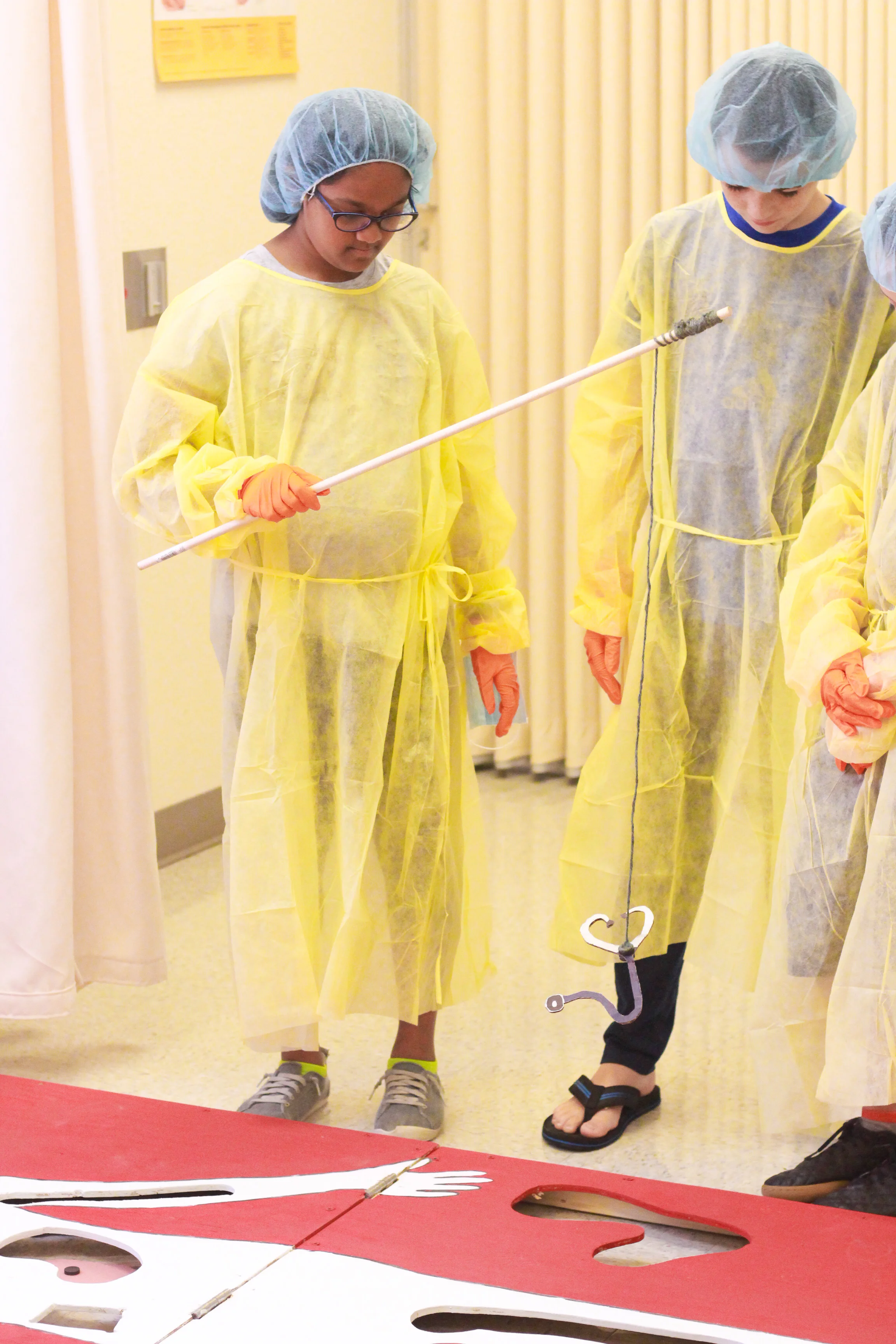 In one station, attendees played a life-size game of operation teaching kids how to operate and remove unwanted items: Photo by Grace Nguyen