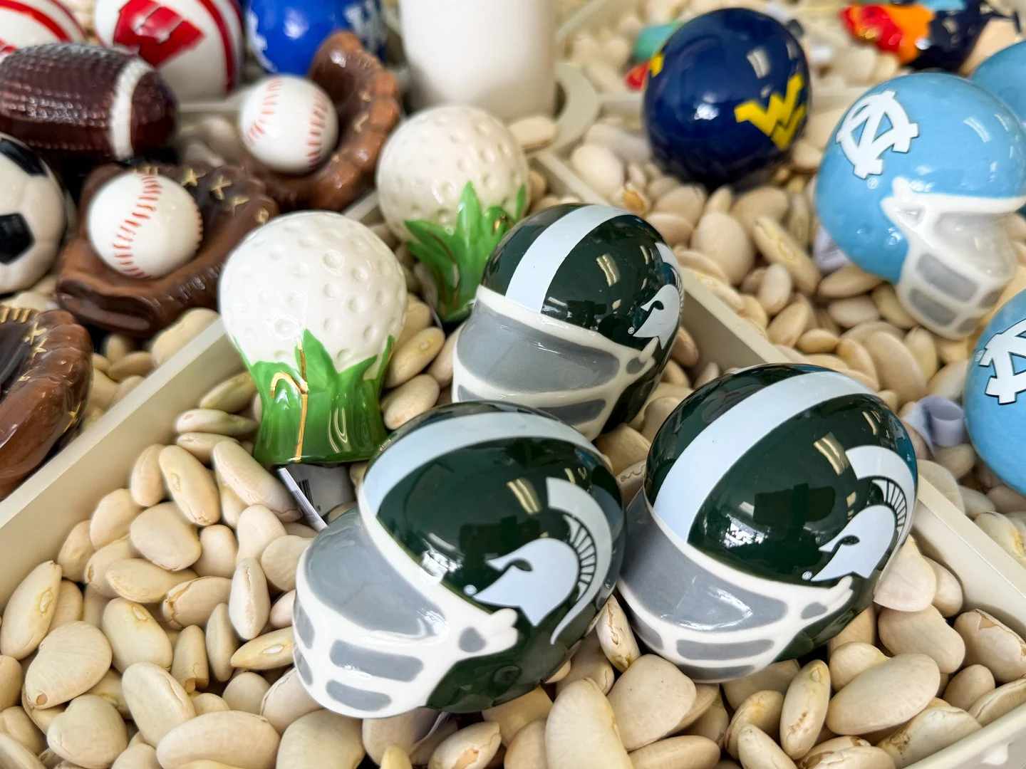 Hand-painted sports-themed ceramic minis, including Michigan State helmets and golf balls