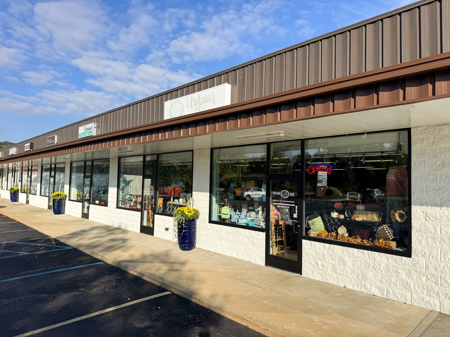 The exterior of Urban Nest Michigan boutique in Richland, showing the storefront windows and entrance under a brown awning