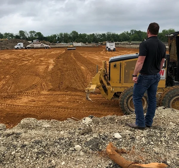 construction site of trucks and red dirt