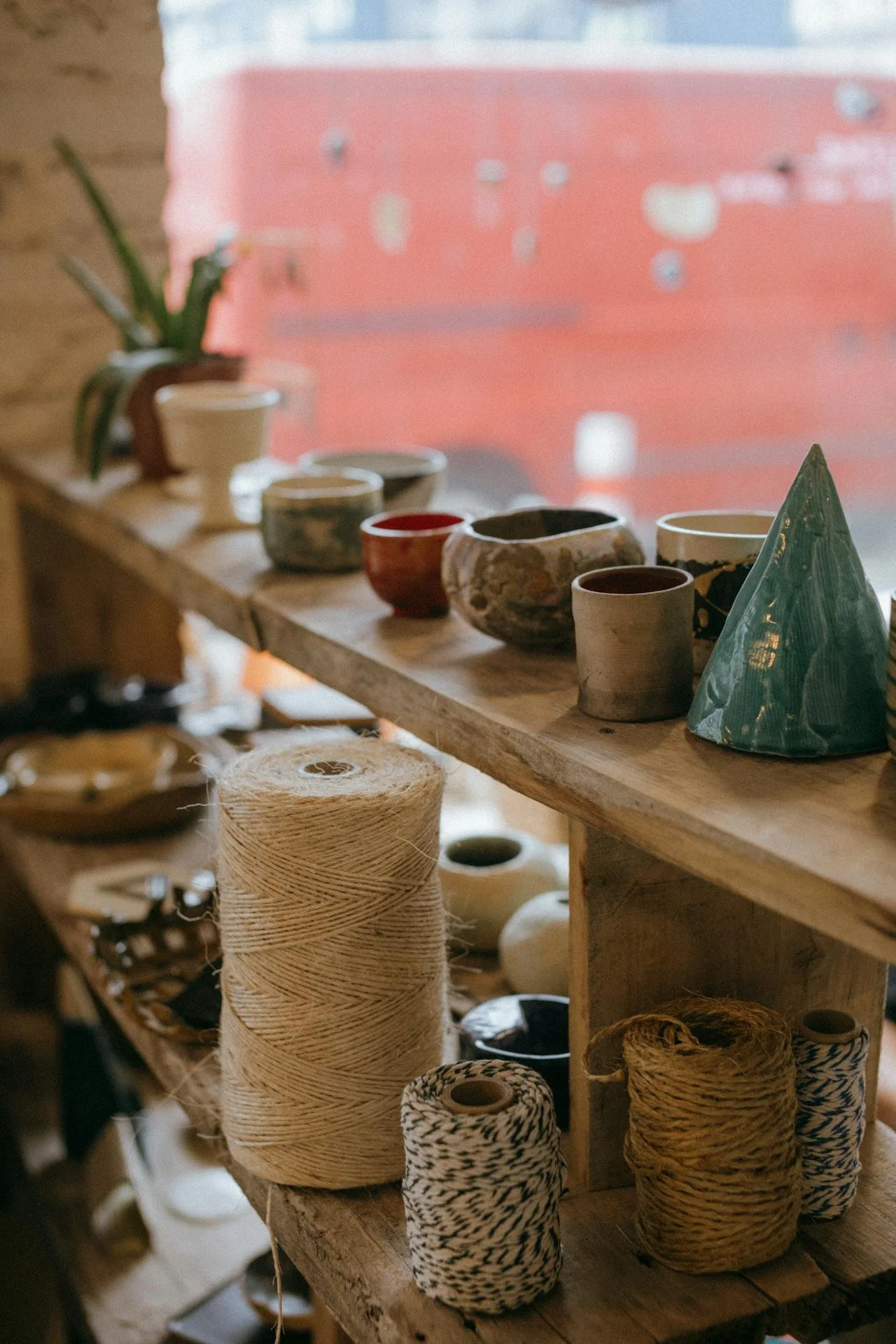 Ceramic bowls sit on a wooden store shelf.